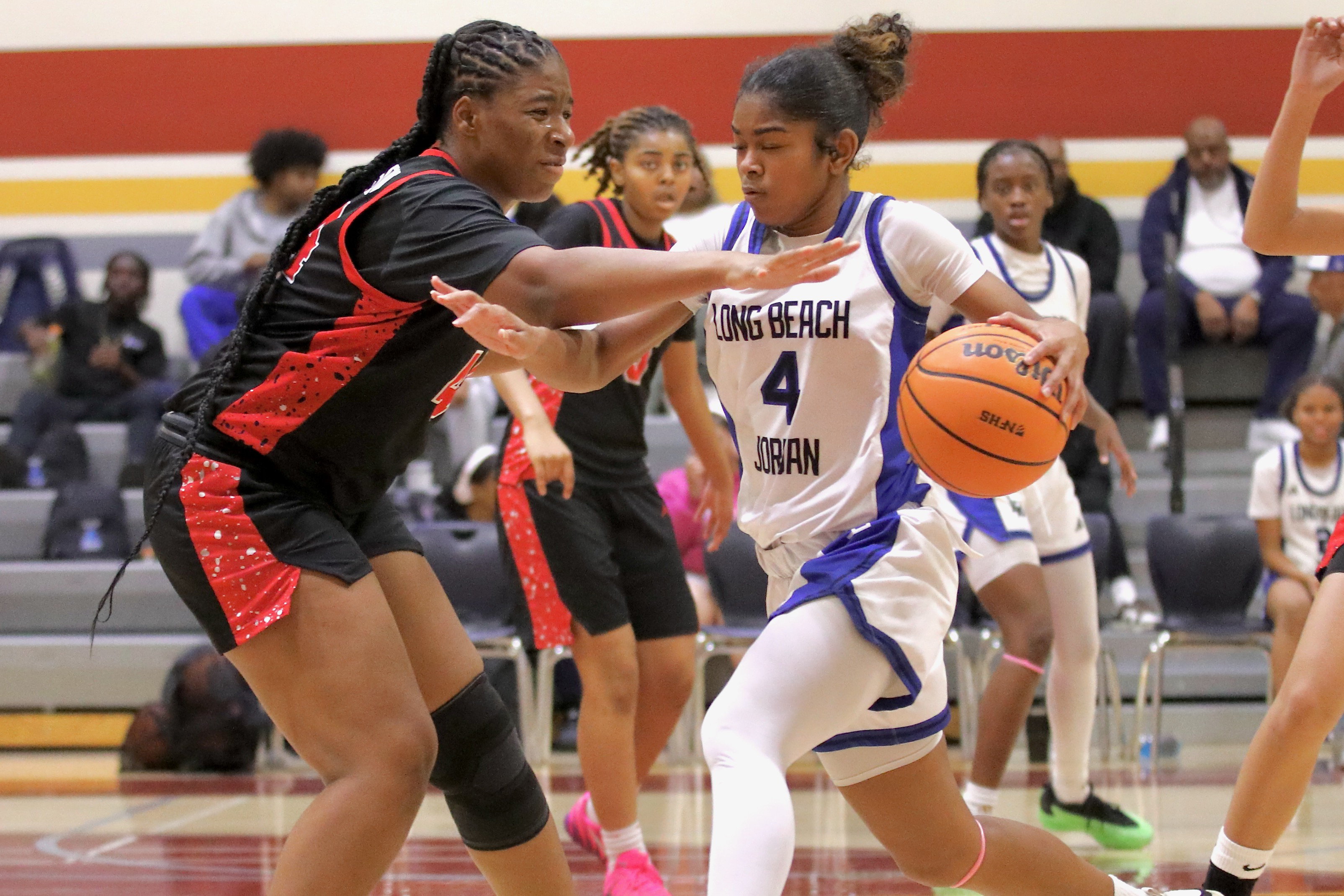 Jordan’s Janiah Lorn drives on Lakewoodâs Kasey-Rian Henson in a...