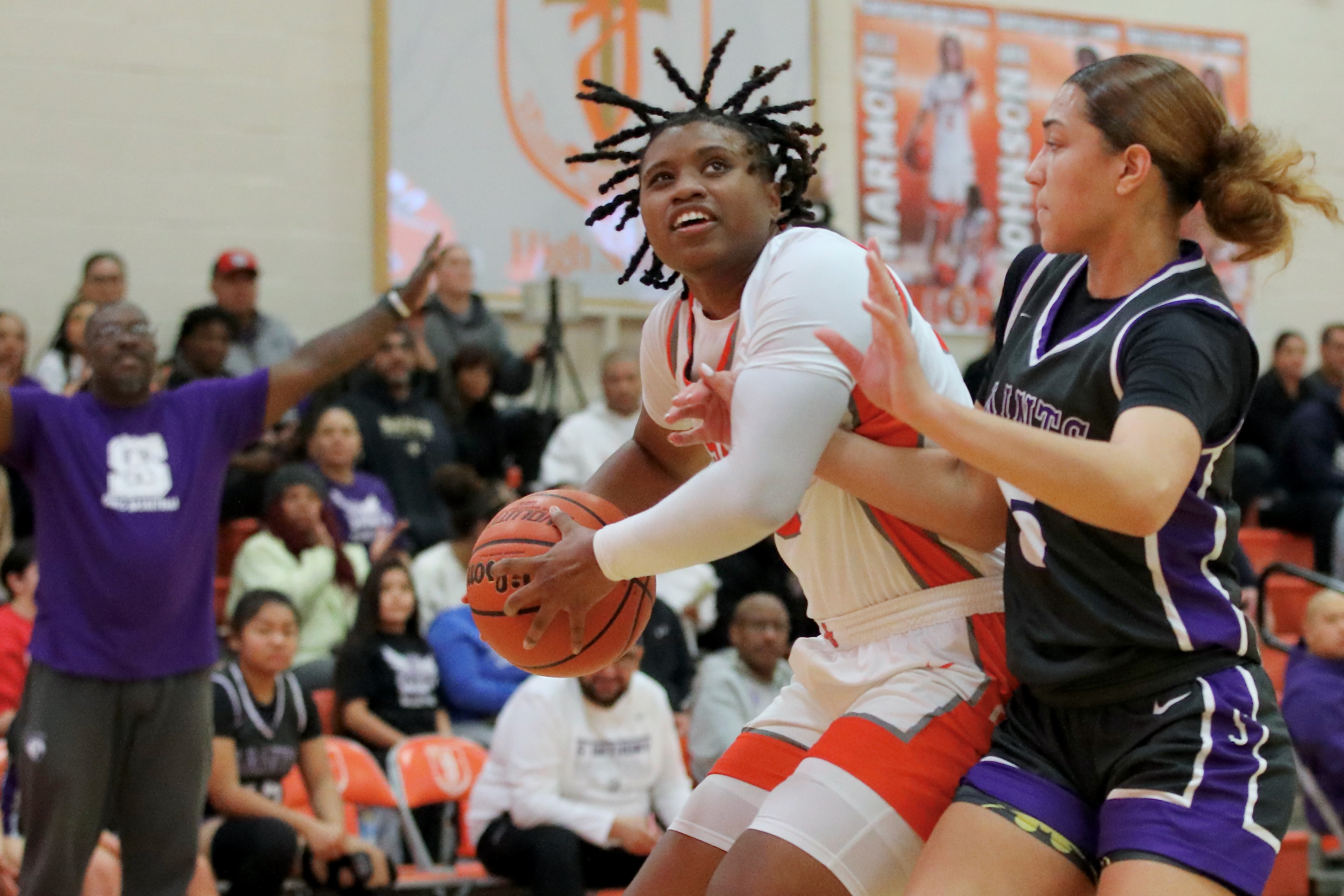 St. Josephâs Aniyah Johnson powers her way to the basket...