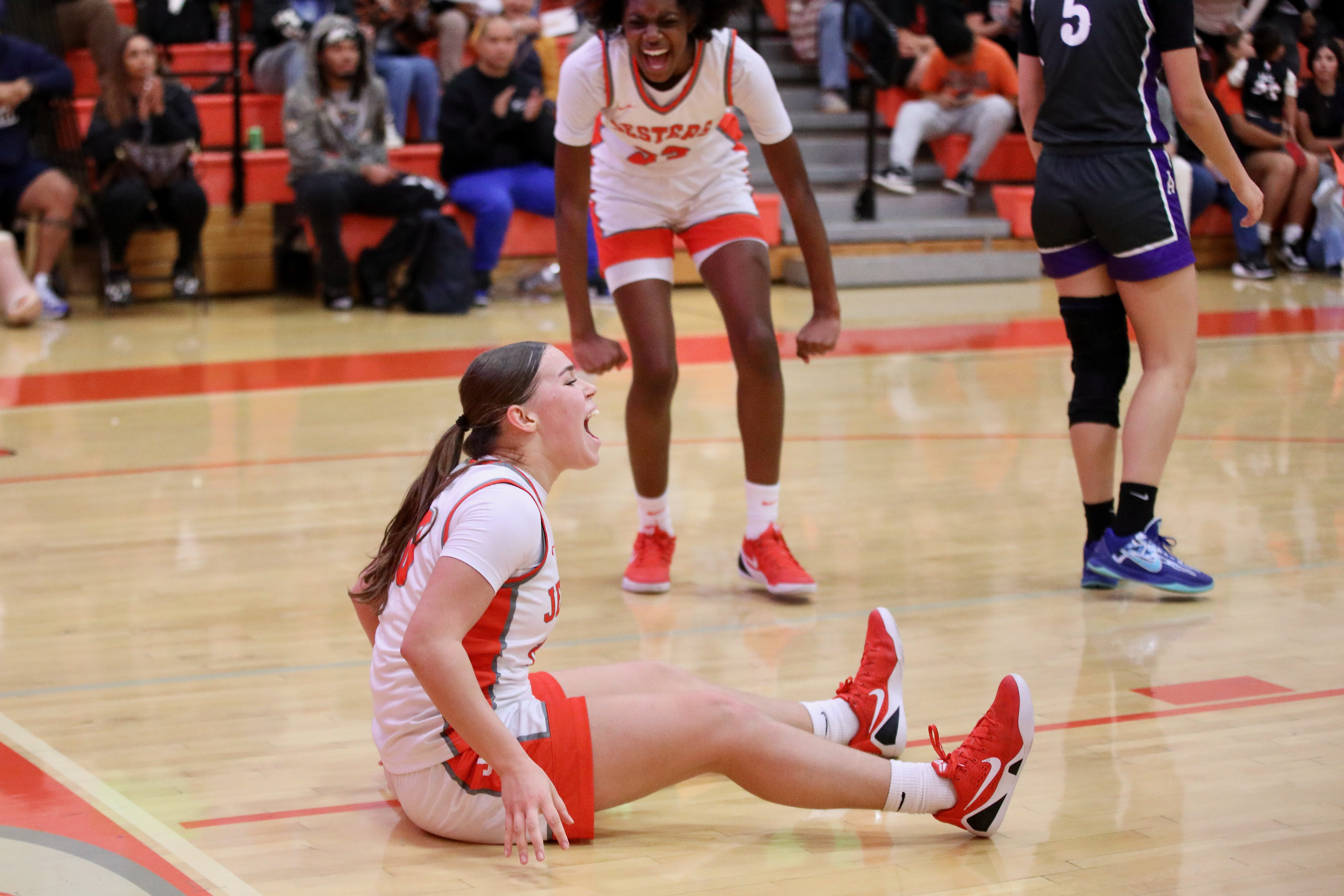St. Joseph junior guard Mia Minshall reacts while sitting on...