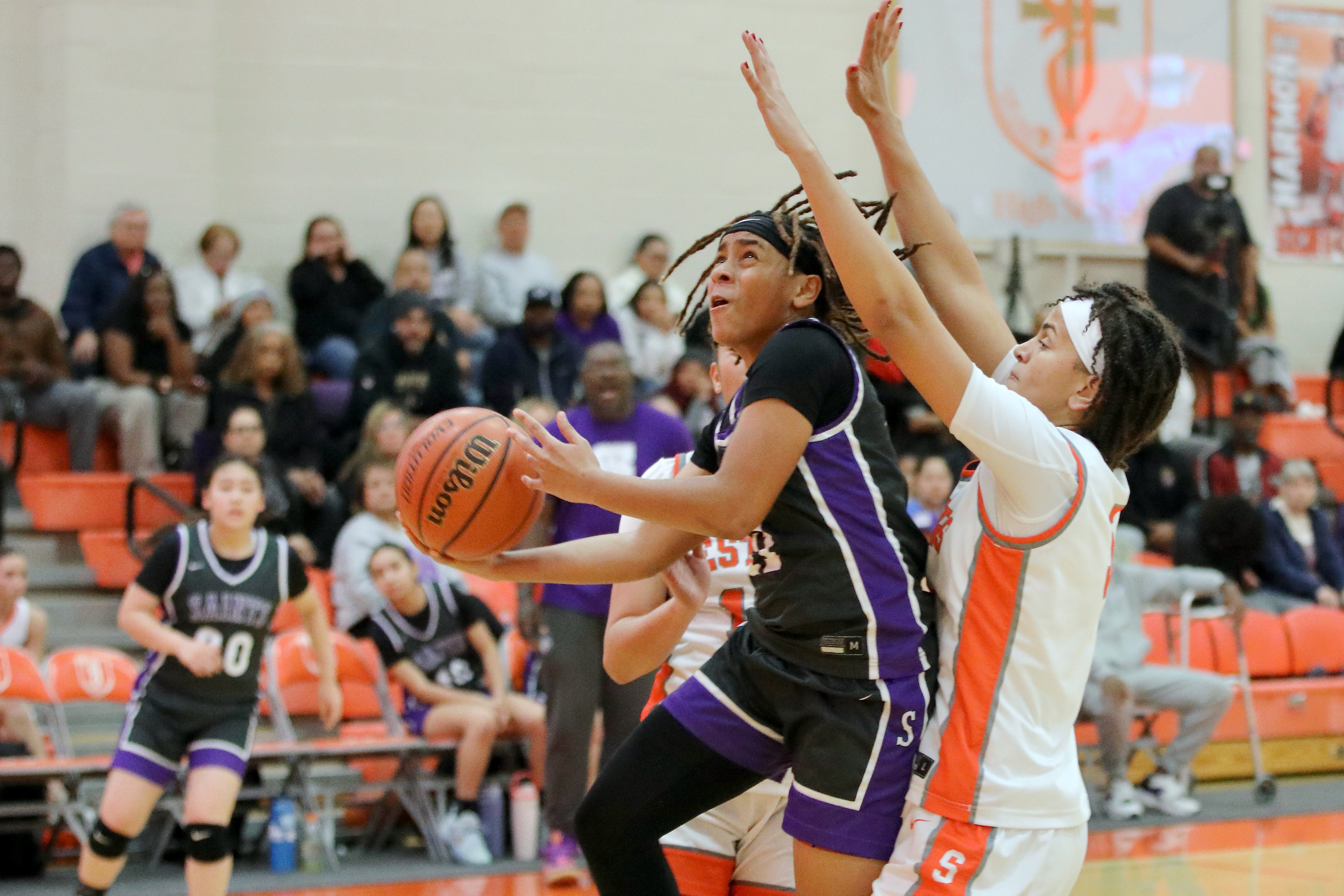St. Anthony senior Jordyn Washington drives to the basket past...