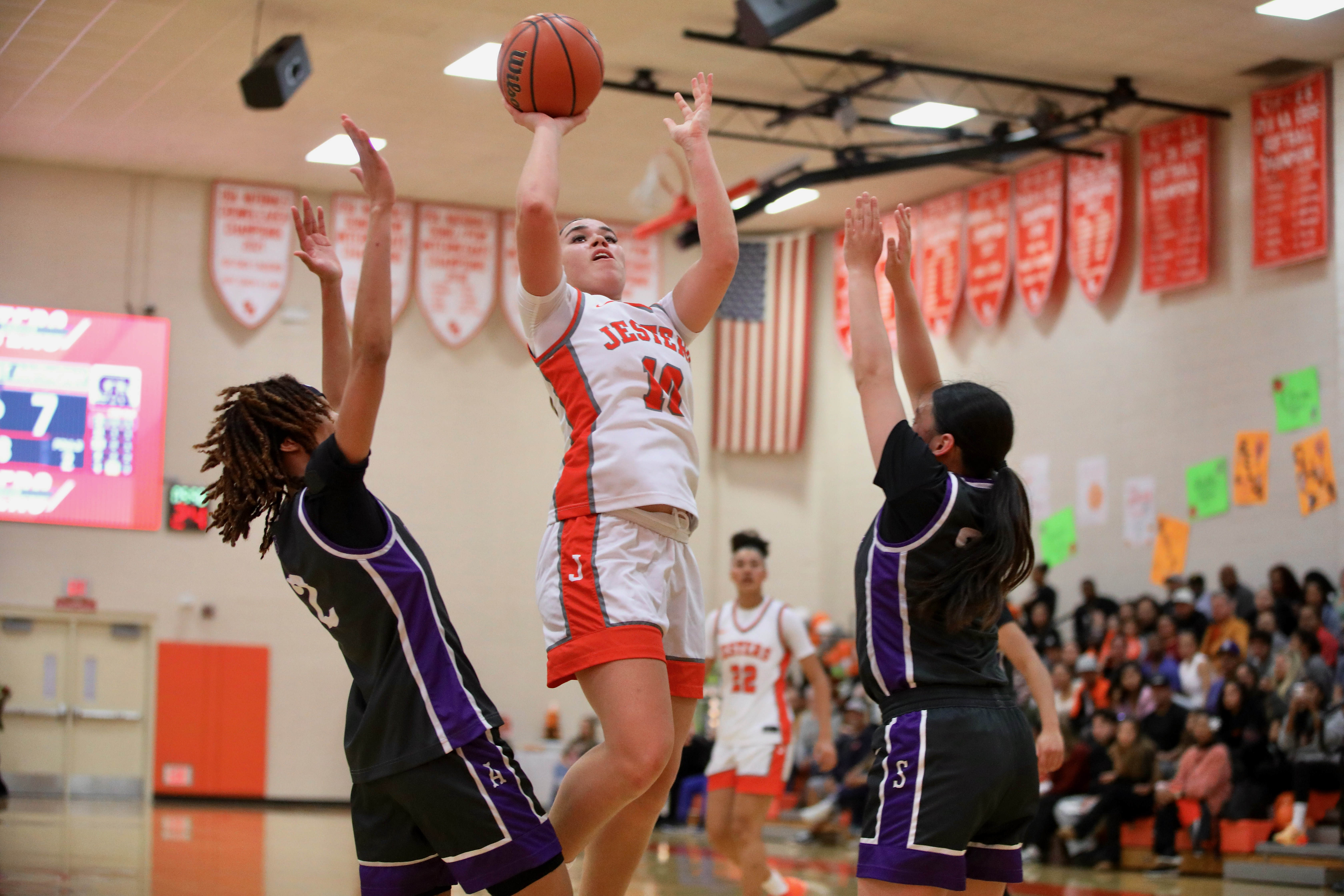 St. Joseph’s Mia Minshall gets off a shot between two...