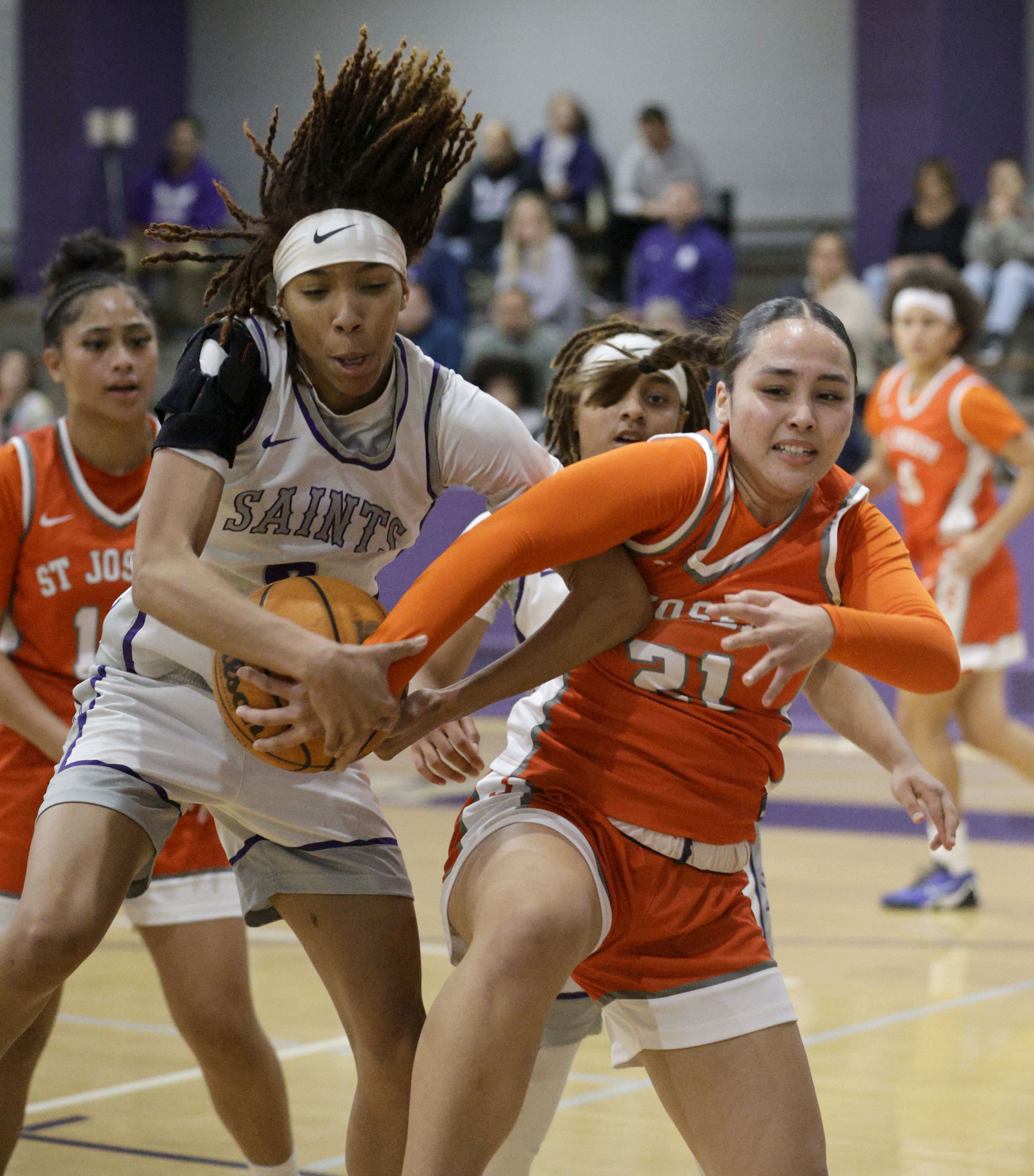 St. Anthonys Laila Hughes (2) and St. Josephs Olivia Molina...