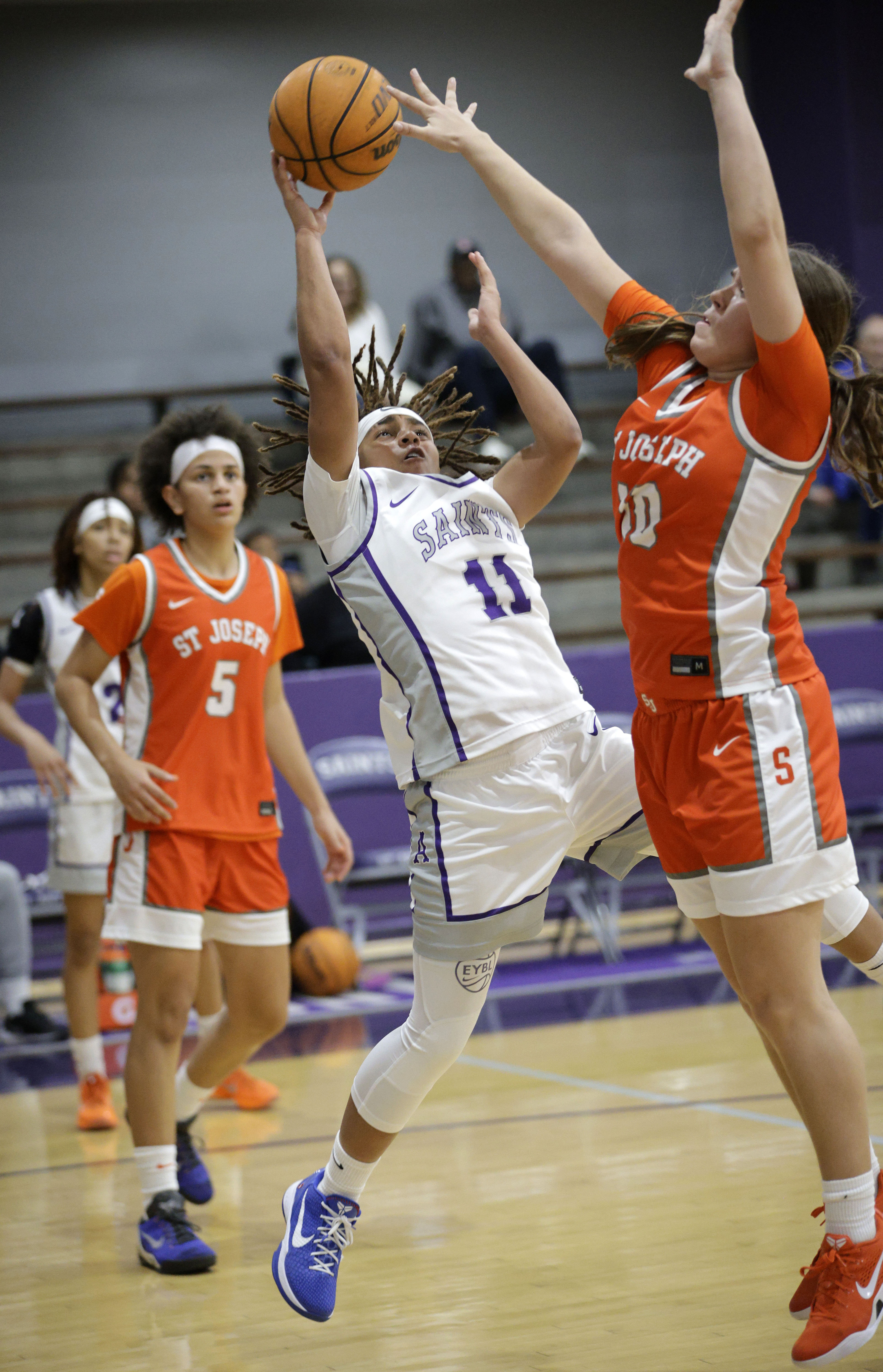 St. Josephs Mia Minshall (10) tries to block St. Anthonys...