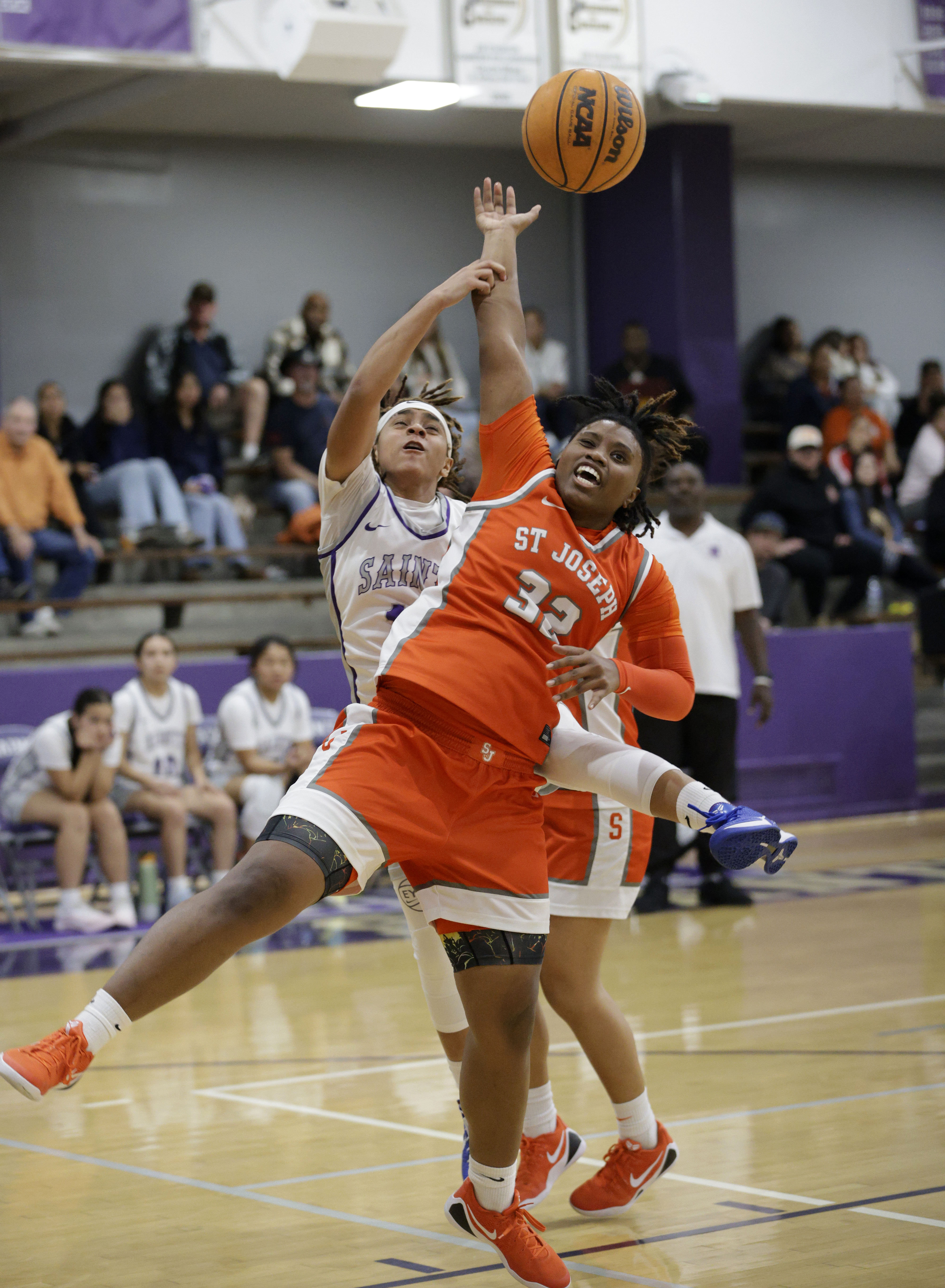 St. Josephs Aniya Johnson (32) blocks St. Anthonys Jordyn Washingtons...