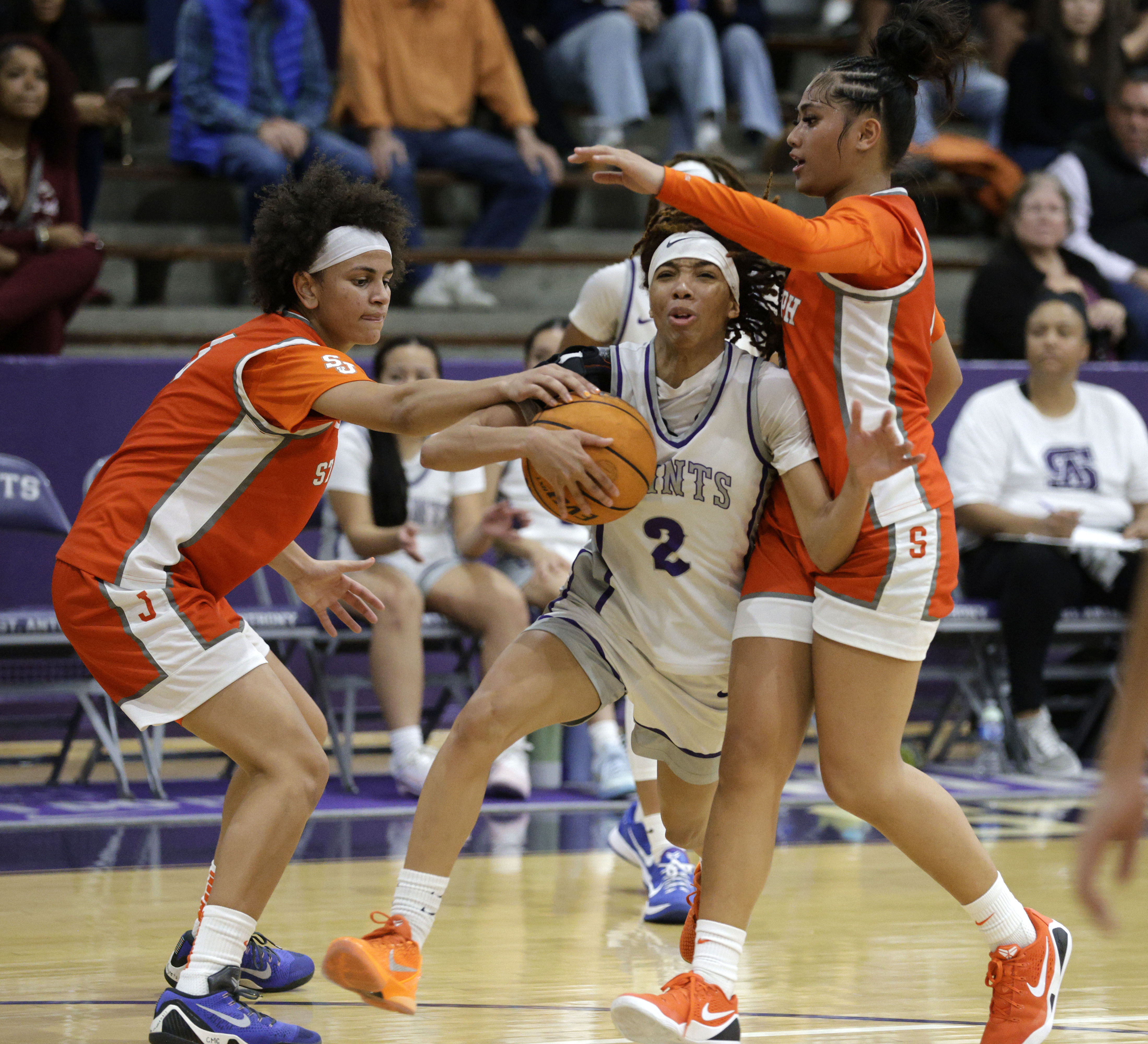 St. Anthonys Laila Hughes (2) tries to get past St....