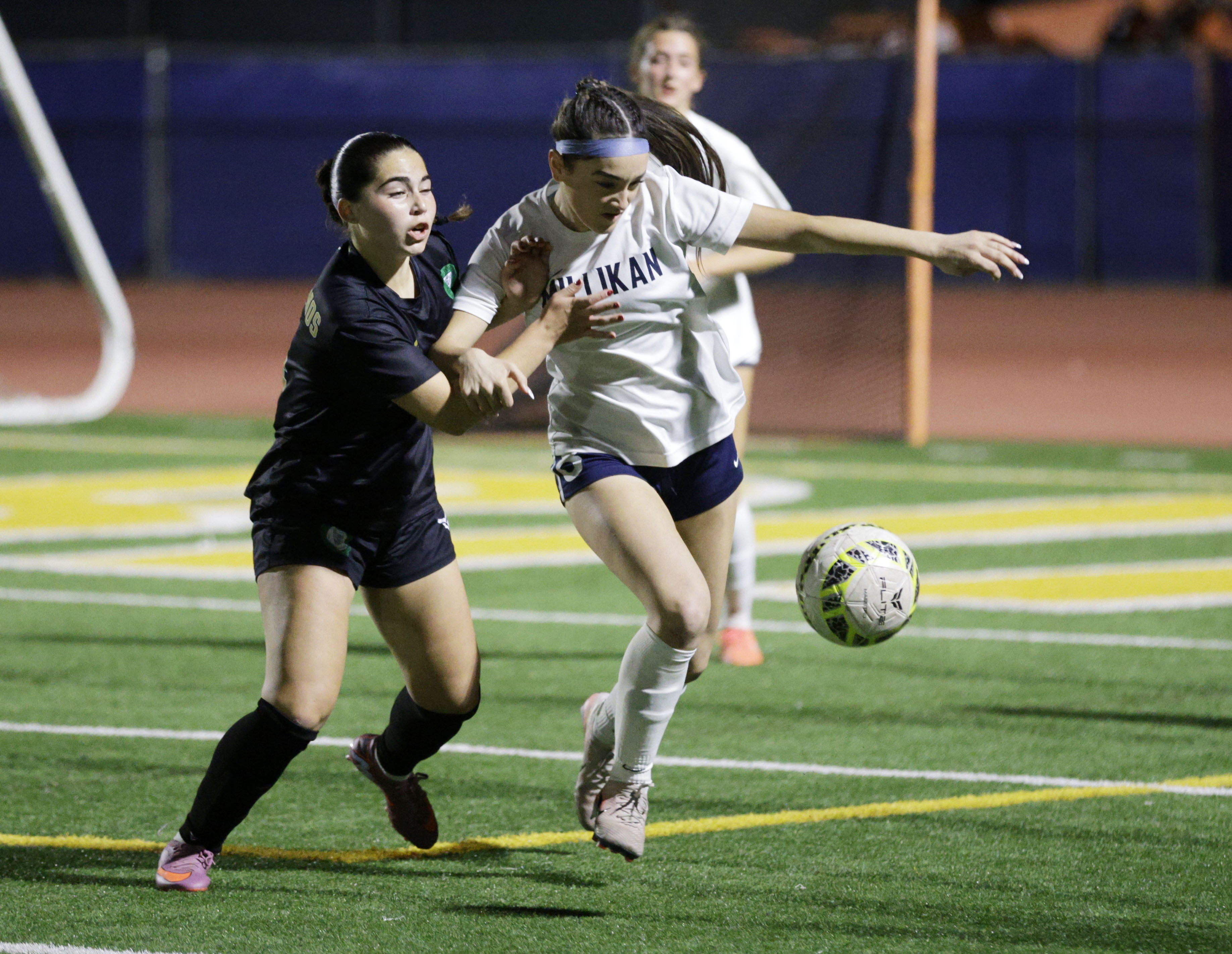Millikan’s Adelyn Murphy (8) tries to break away from Long...