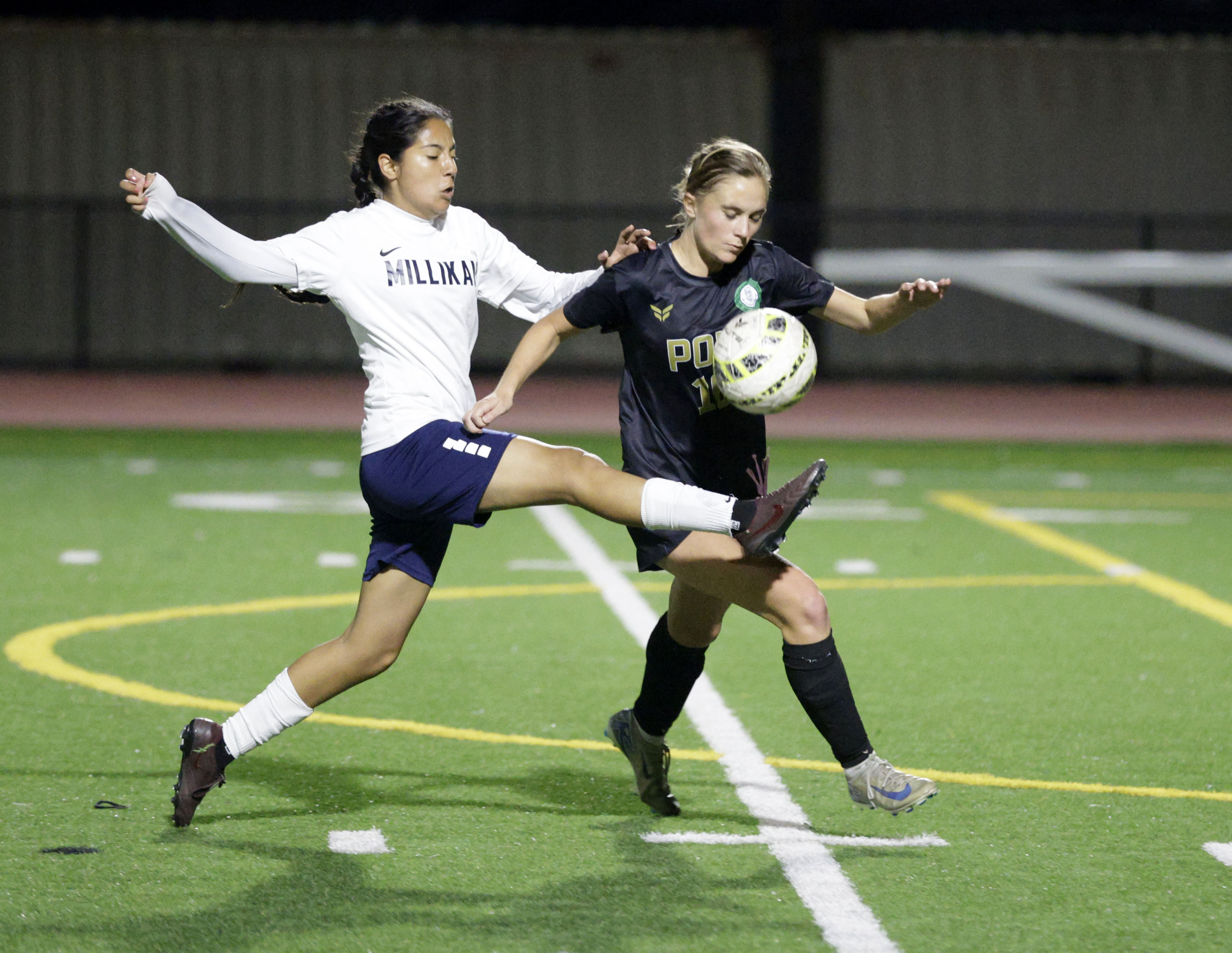 Millikan’s Alexandra Rios (7) tries to kick the ball away...