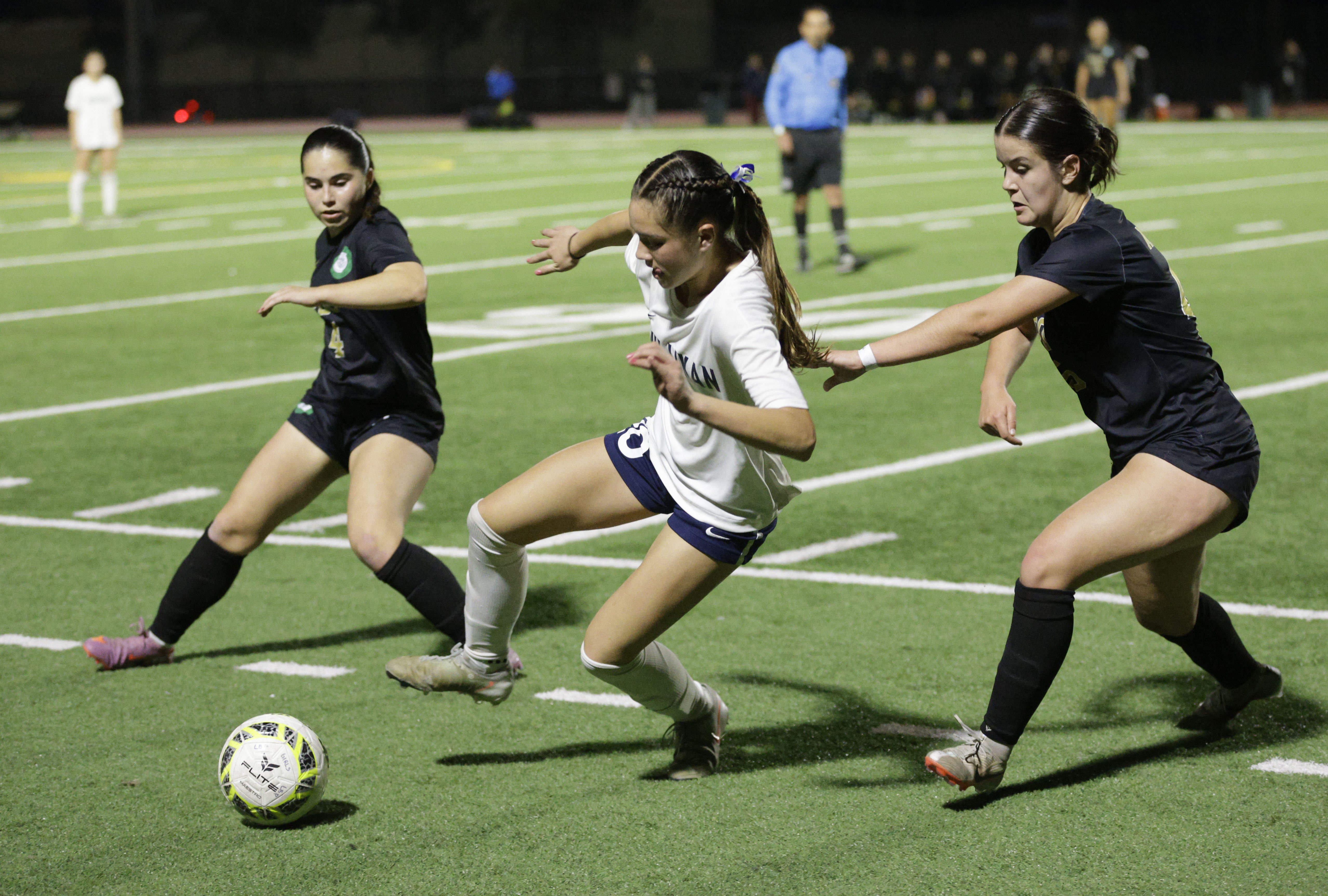 Millikan’s Ellie Carungcong (20) tries to keep the ball from...