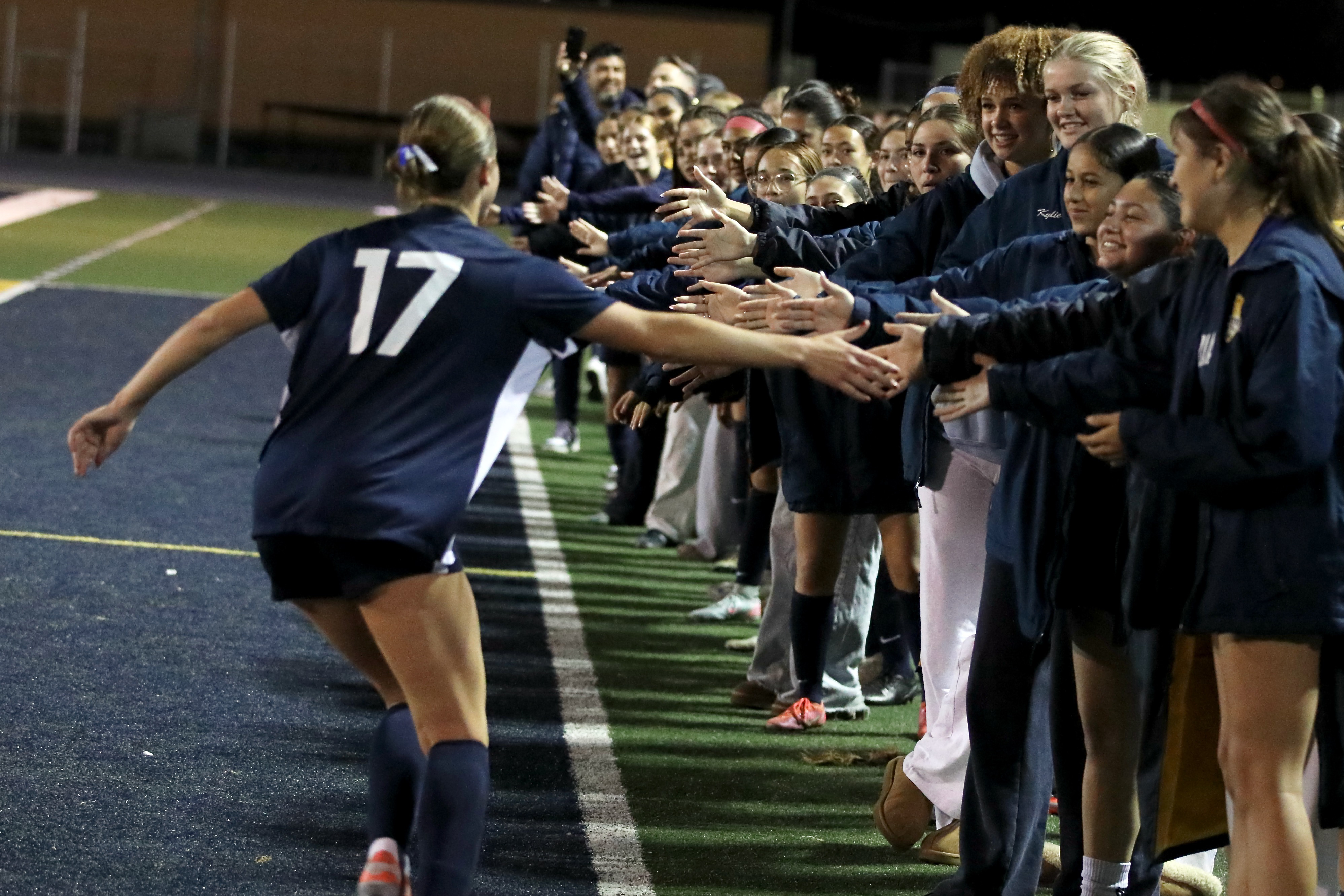 Millikanâs Sarah Thaut is congratulated by teammates after the junior...