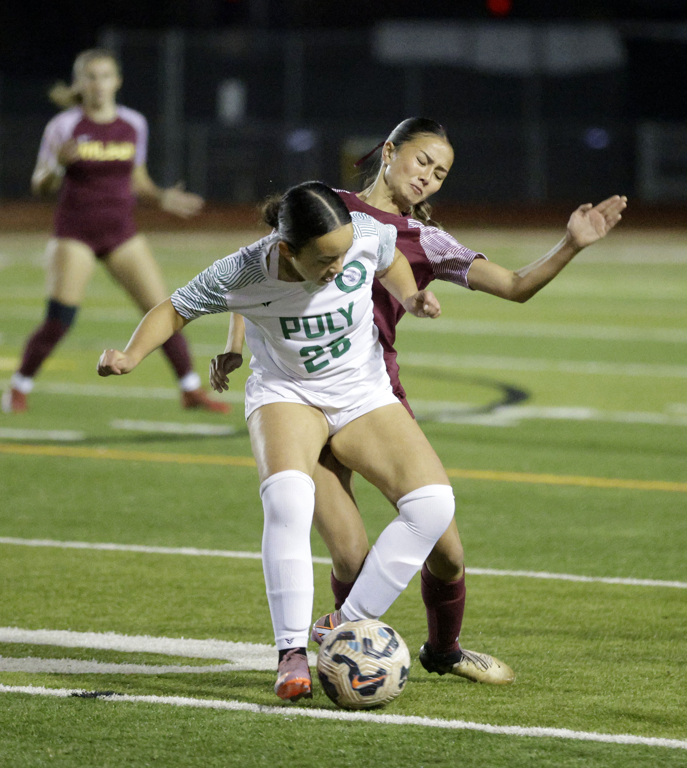 Long Beach Poly’s Claire McFarland (28) keeps the ball from...