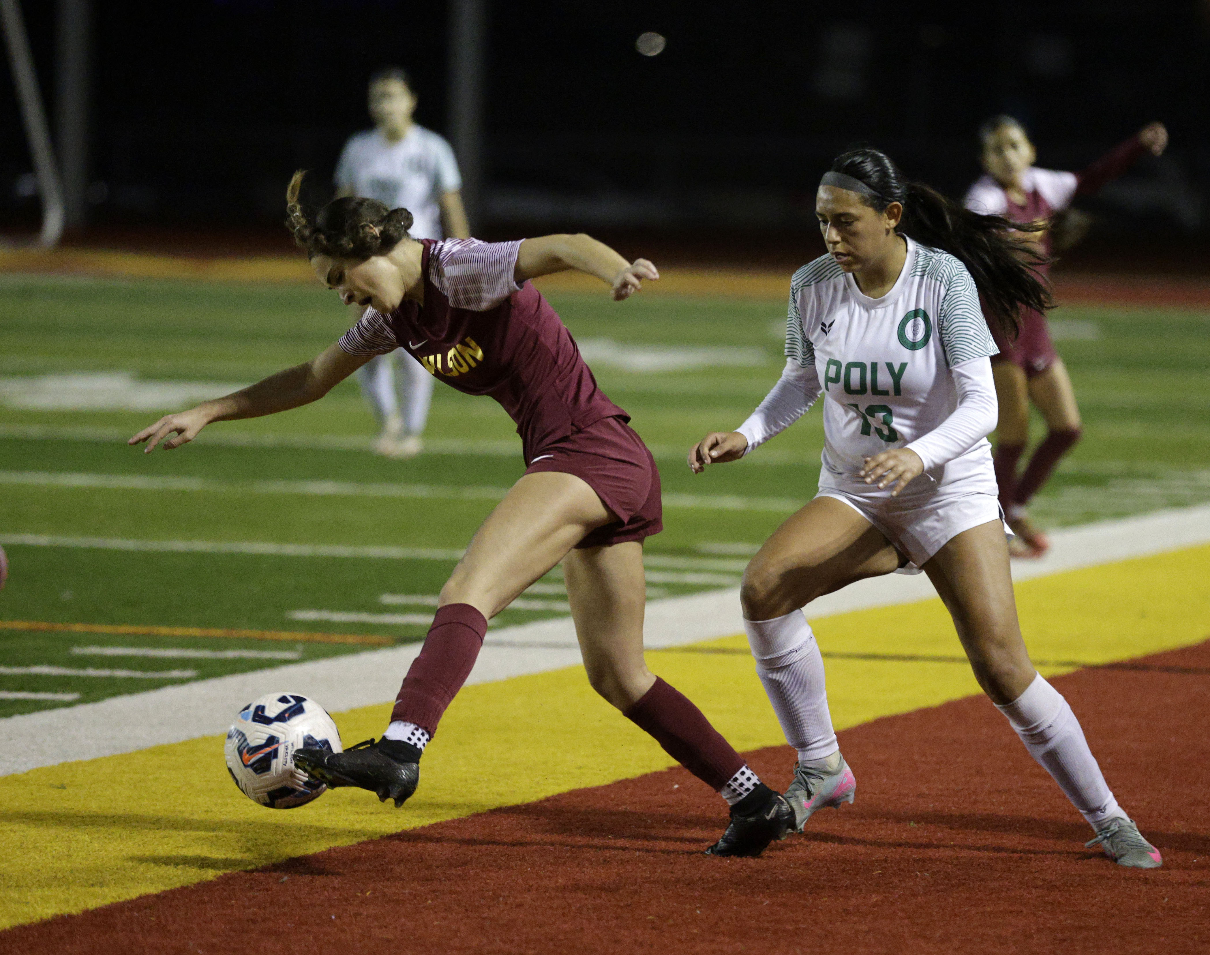 Wilson’s Evan Cassidy (3) keeps the ball from Long Beach...