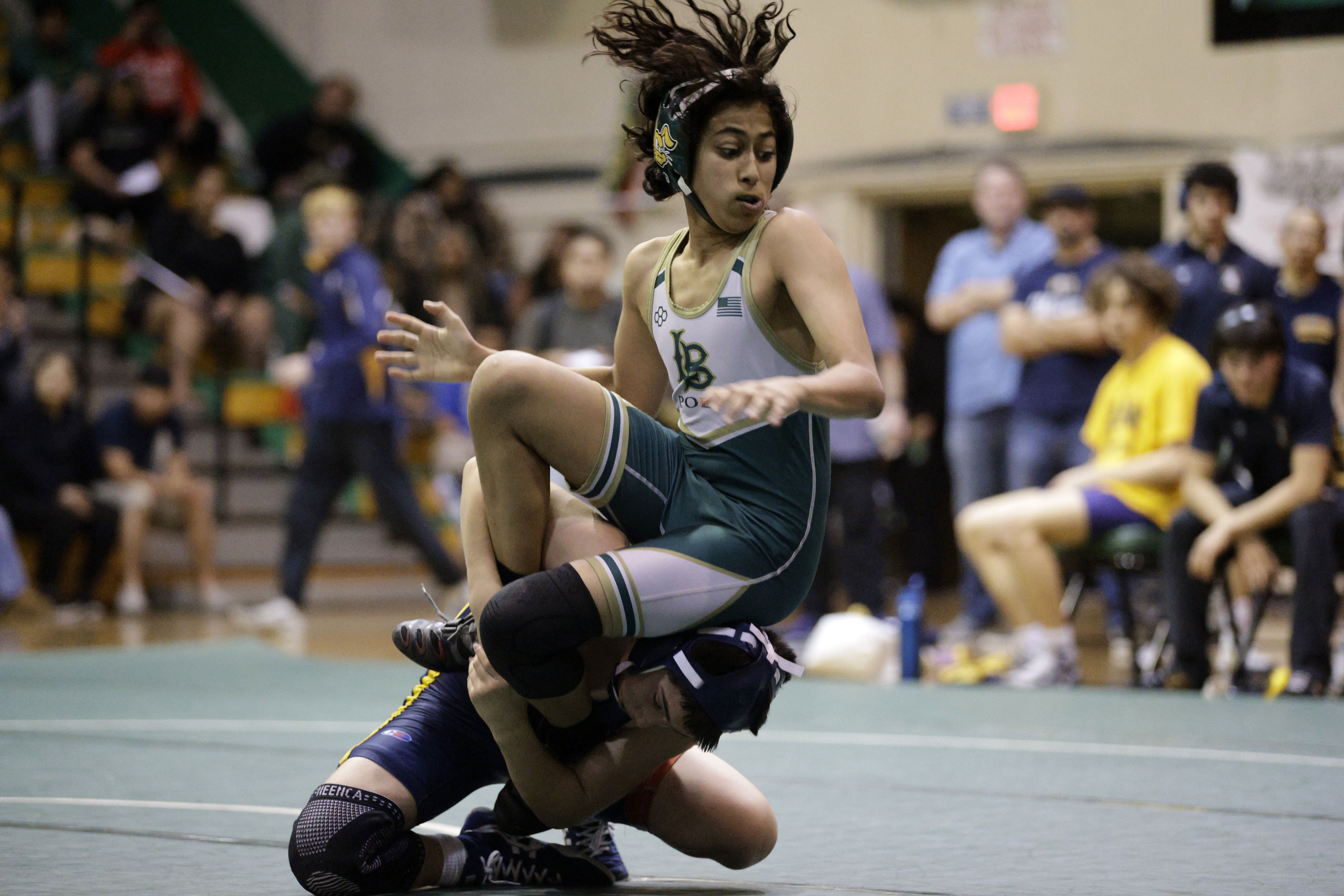 Long Beach Poly’s Ahmad Rawashdeh takes on Millikan’s Anthony Avelar...