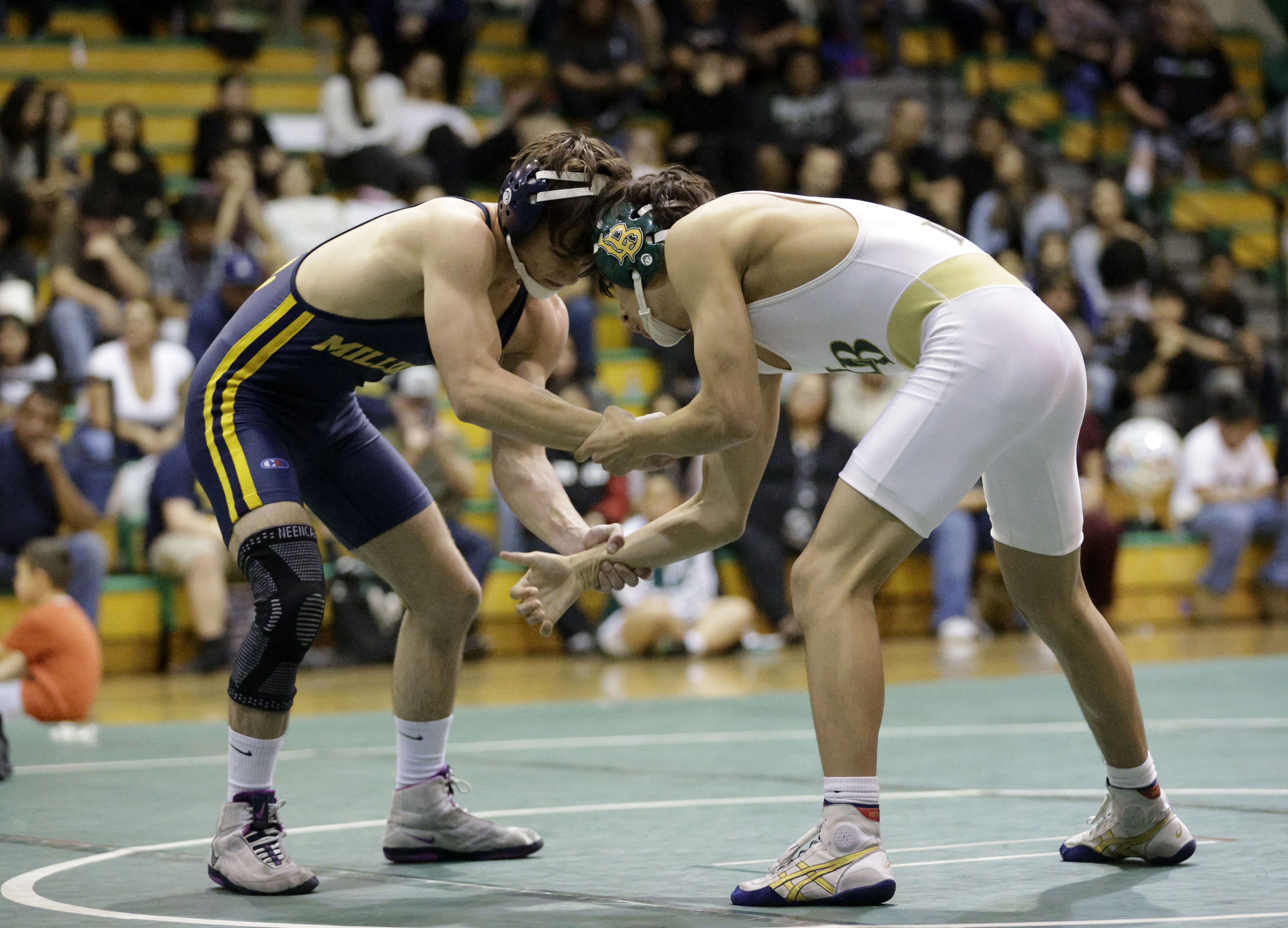 Millikan’s Chase Antrobius takes on Long Beach Poly’s Knox Espinoza...