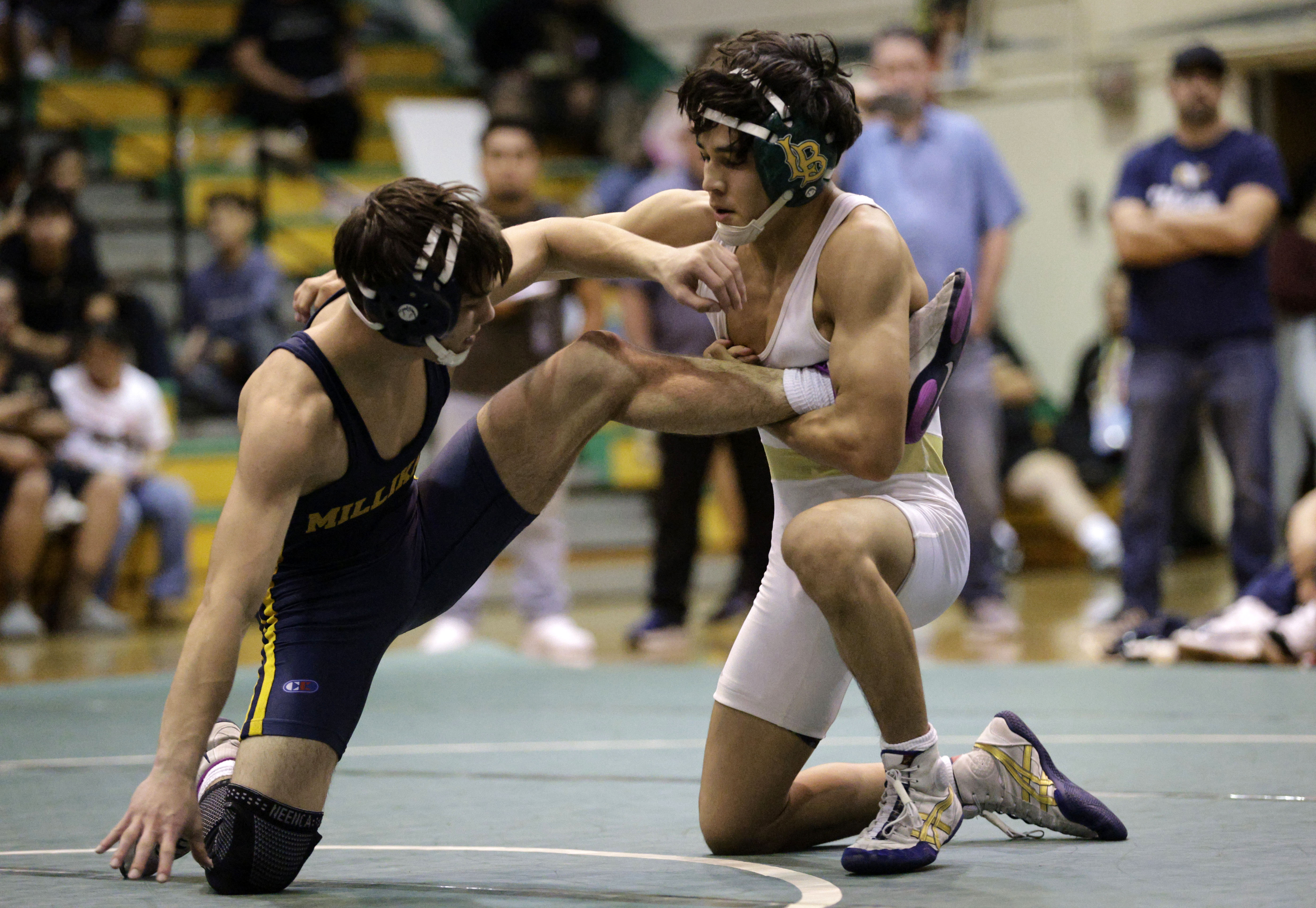 Millikan’s Chase Antrobius takes on Long Beach Poly’s Knox Espinoza...