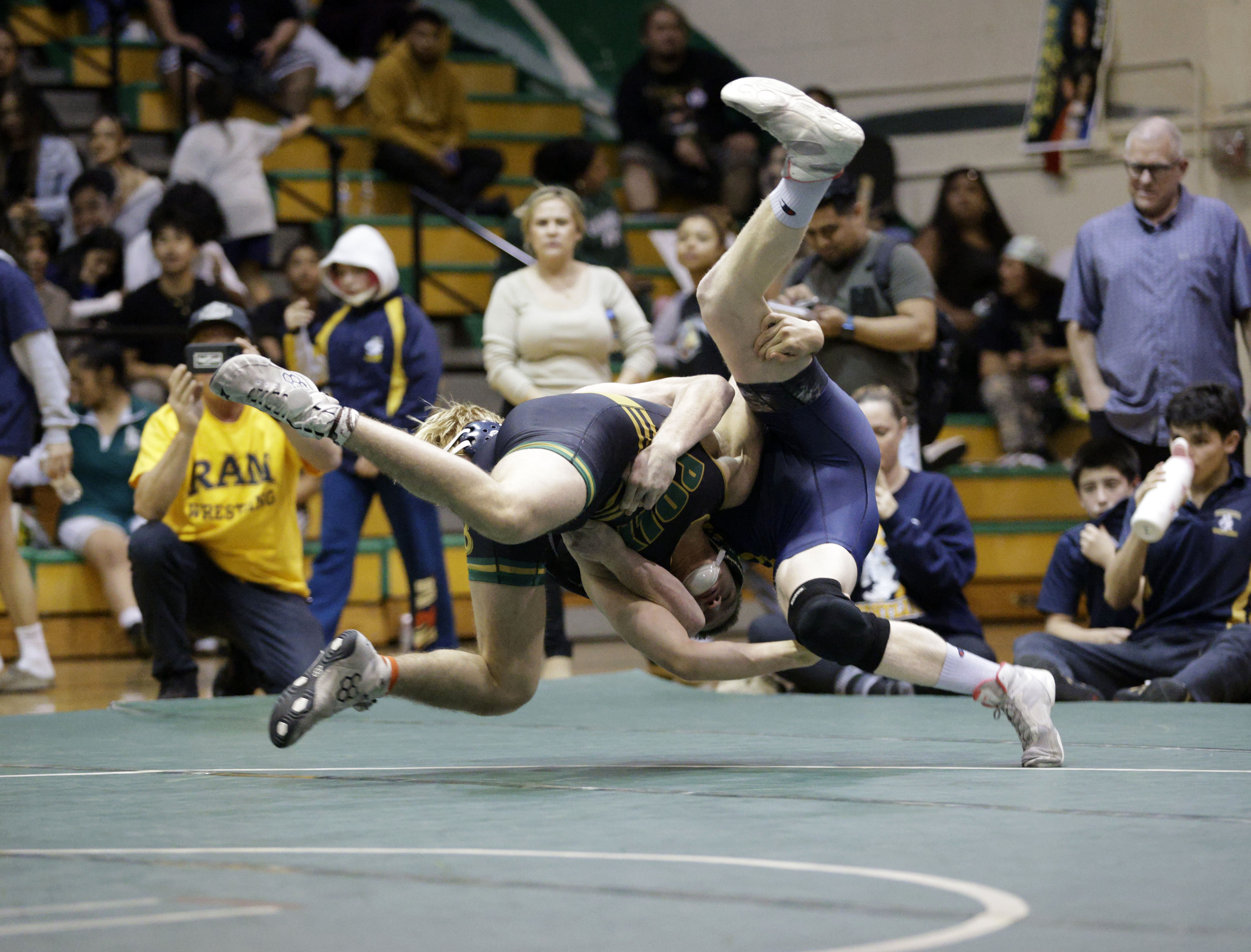 Millikan’s Wyatt Durst takes on Long Beach Poly’s Alex Carrera...