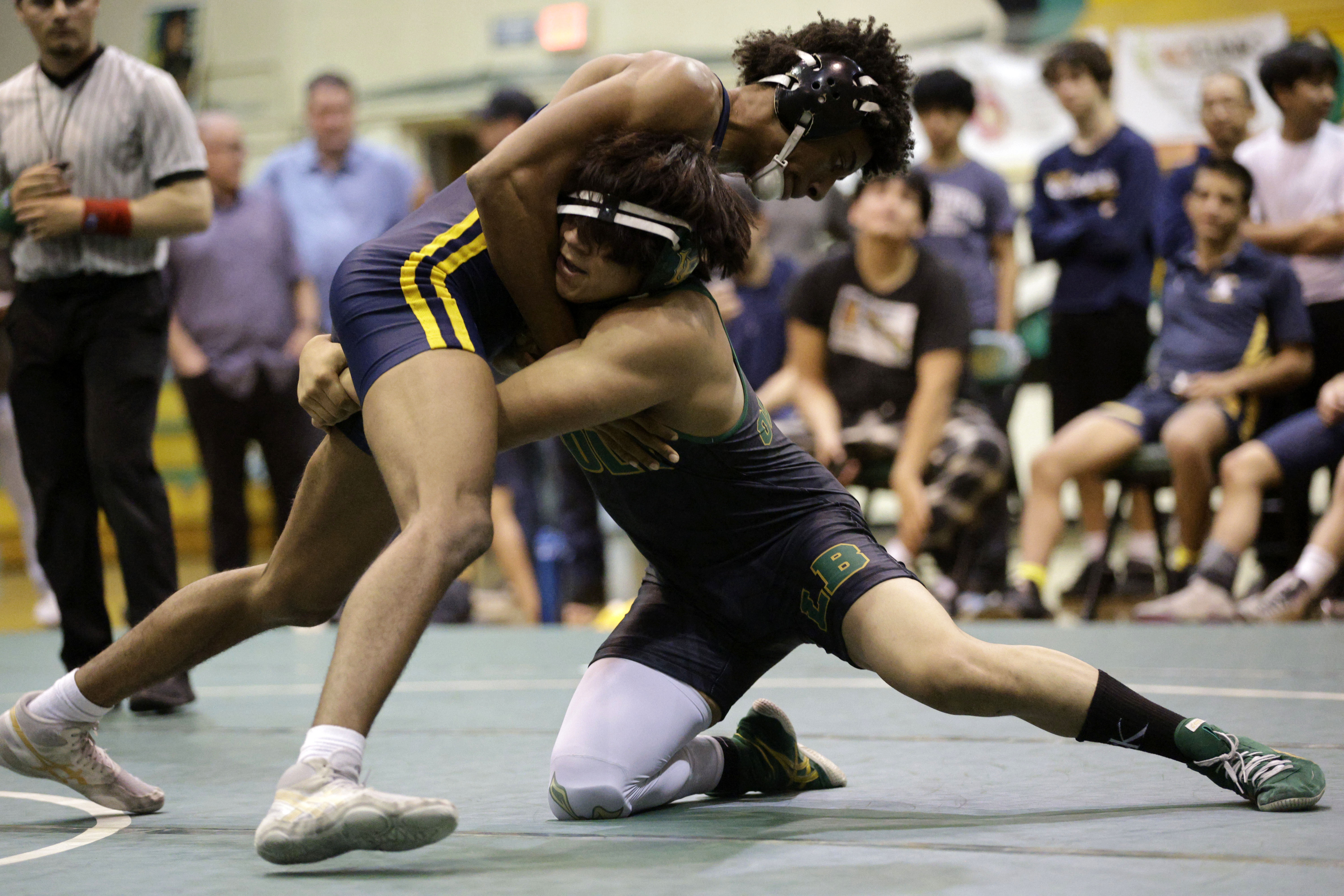 Millikan’s Evan Bradley takes on Long Beach Poly’s Alberto Olague...