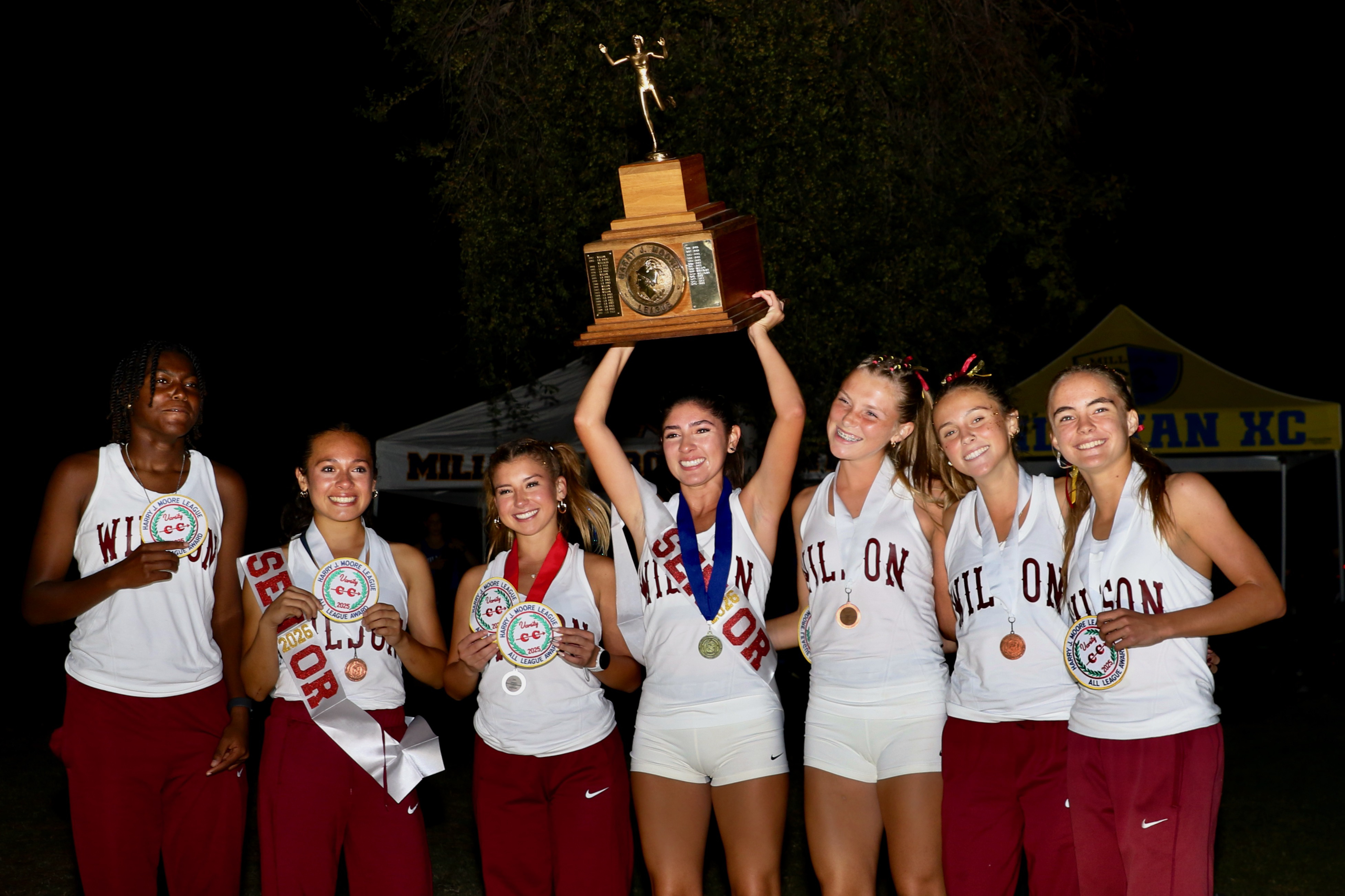 Wilsonâs Nadia Mejia raises the Moore League girls team championship...