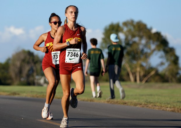 Wilson's Riley Jones and Ashlei Aguayo stay close to the lead in the Moore League cross country cluster meet 1 in Long Beach, CA, on Wednesday, Sept. 24, 2025. (Photo by Tracey Roman, Contributing Photographer)