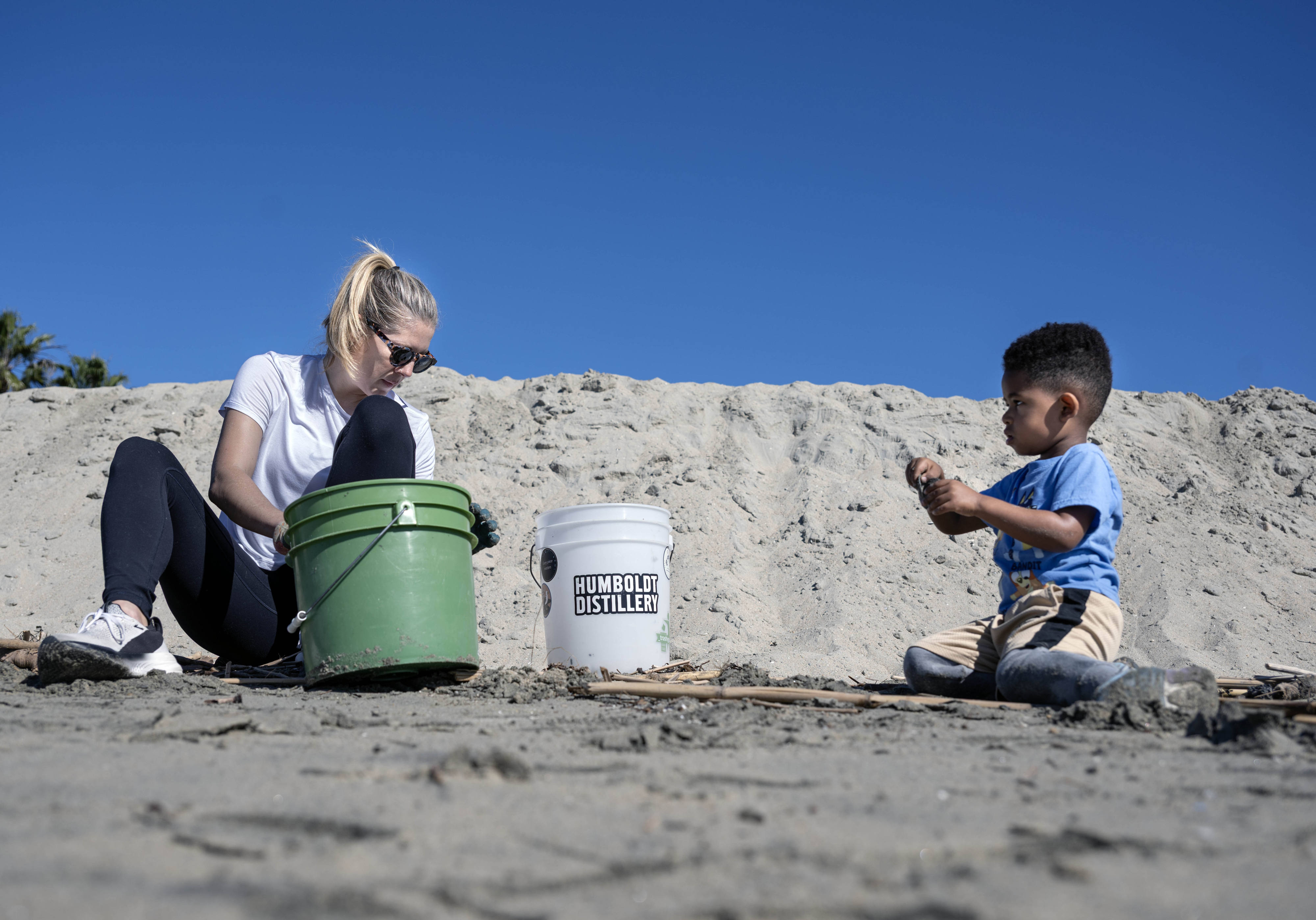 Crystal Cadle siftsÂ through the sand as she looks for microplastics...
