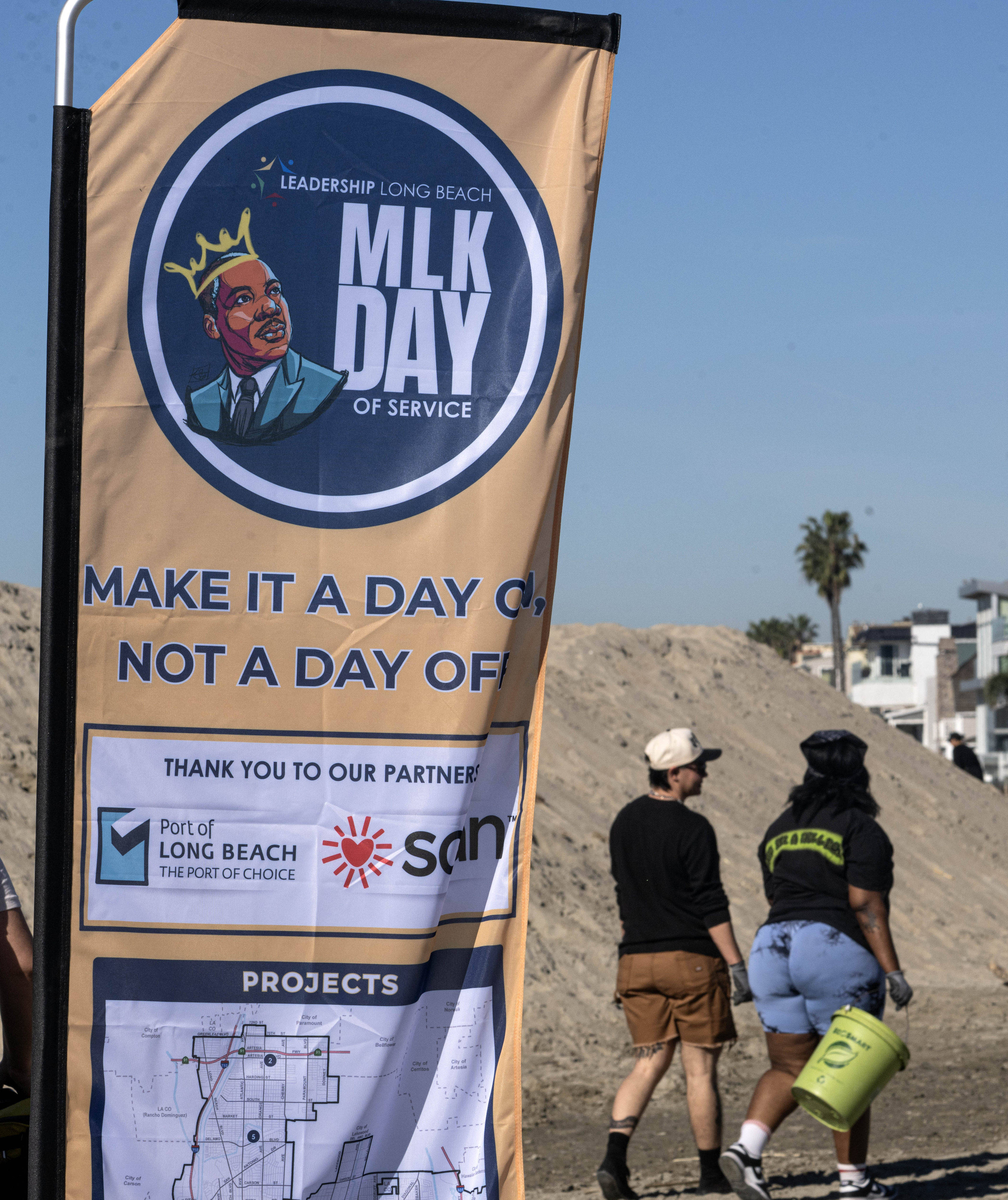 Dozens of volunteers pick up trash on the Long Beach...
