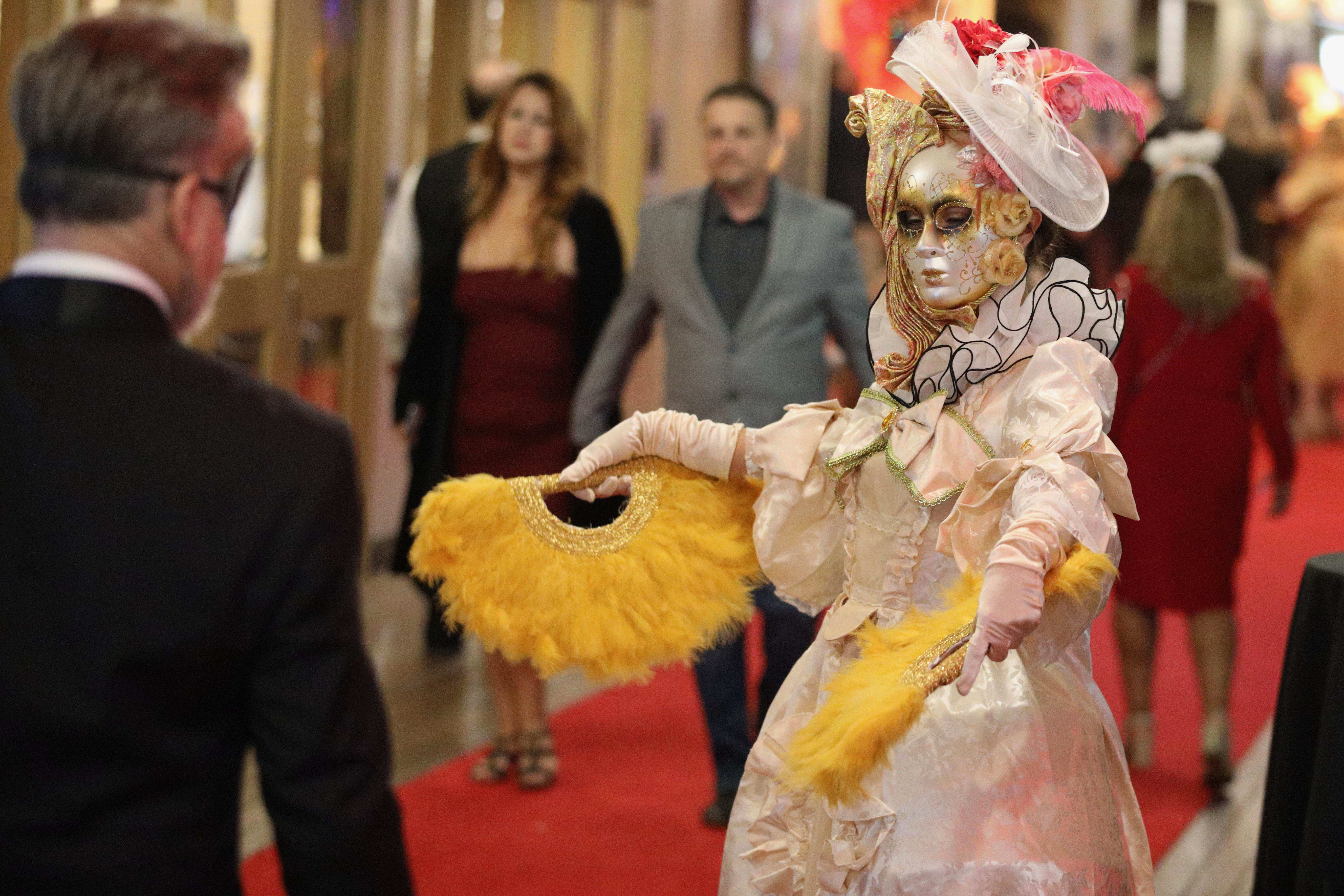 A performer greets revelers at the Queen Maryâs New Yearâs...