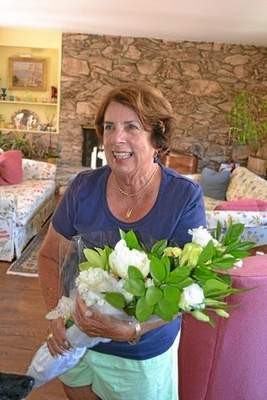 Susan Bell holds flowers after being named Rick Racker Woman...