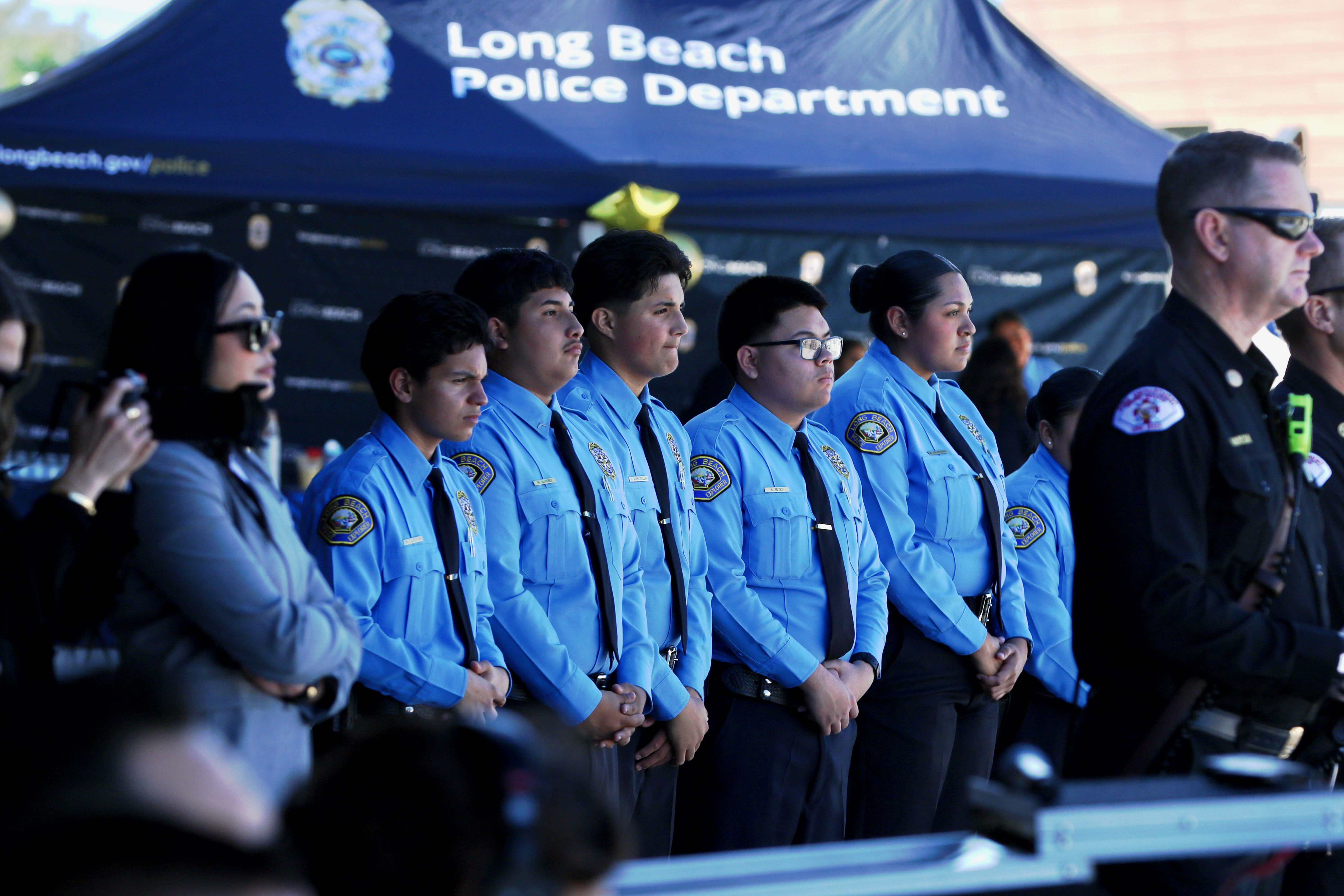 Long Beach Police Department Explorers attend the grand opening and...