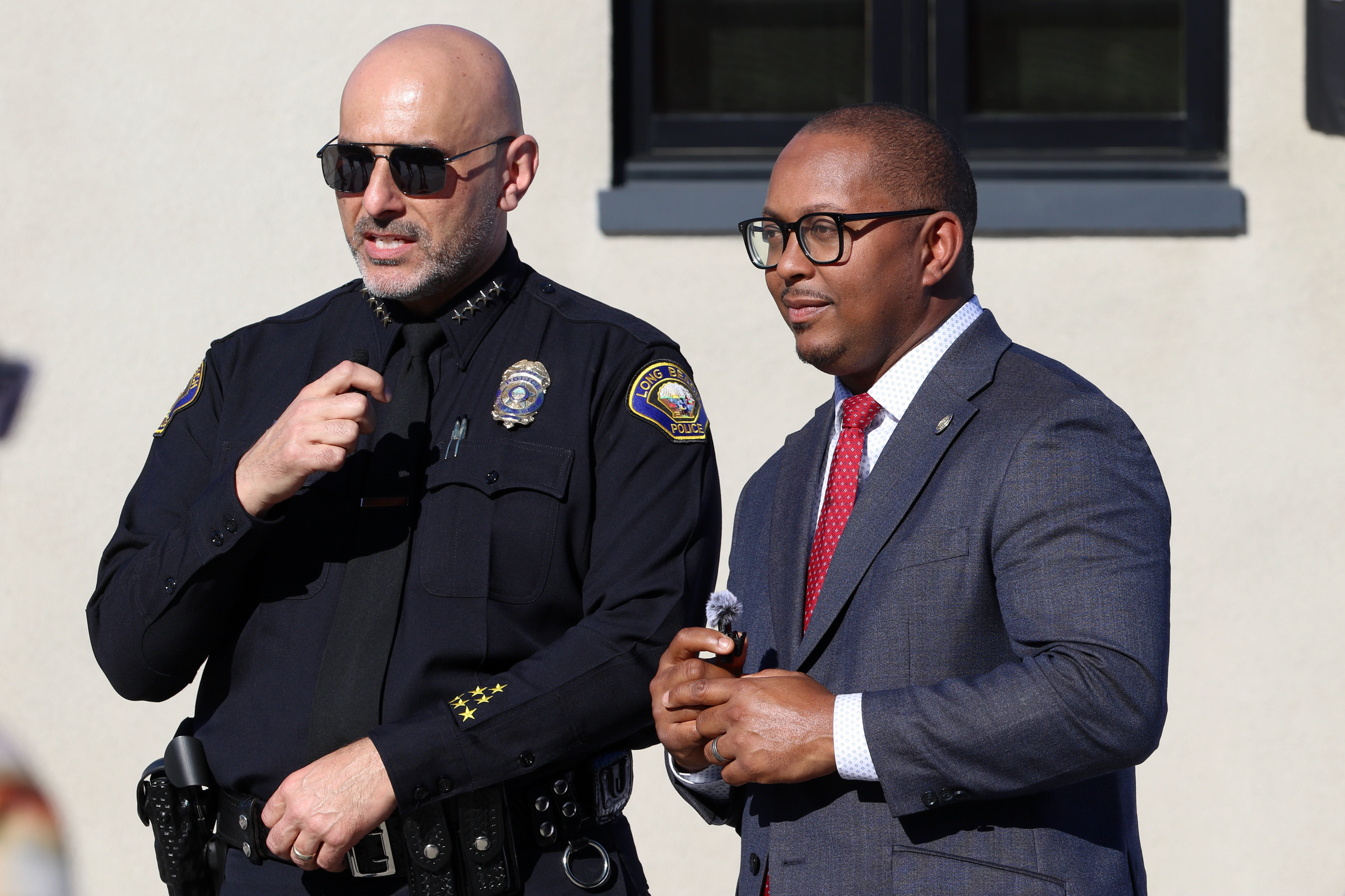 Police Chief Wally Hebeish, left, and Mayor Rex Richardson greet...