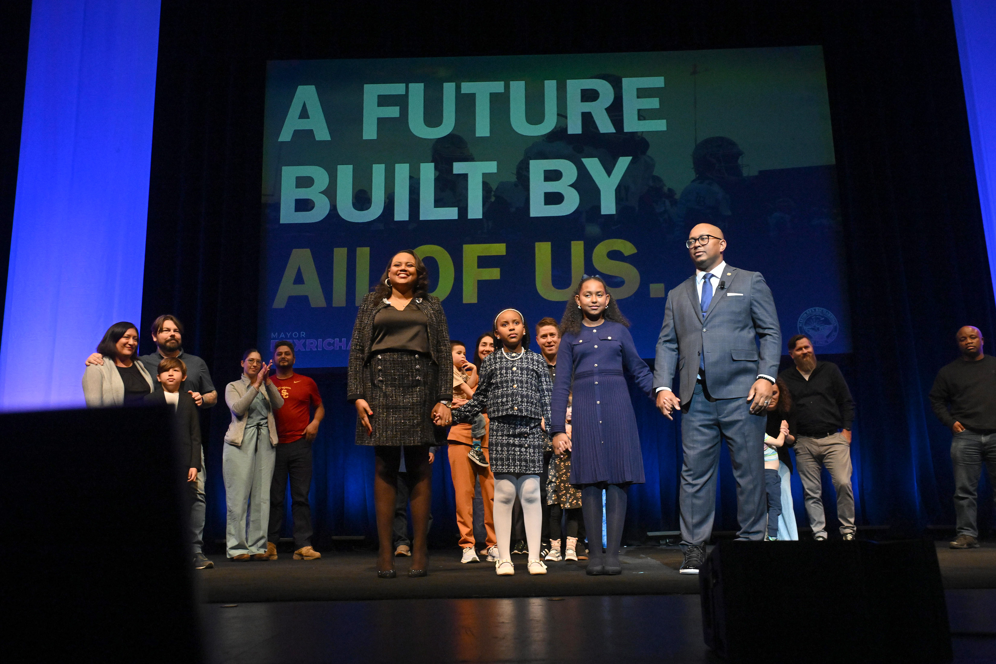Long Beach Mayor Rex Richardson is joined on stage by...
