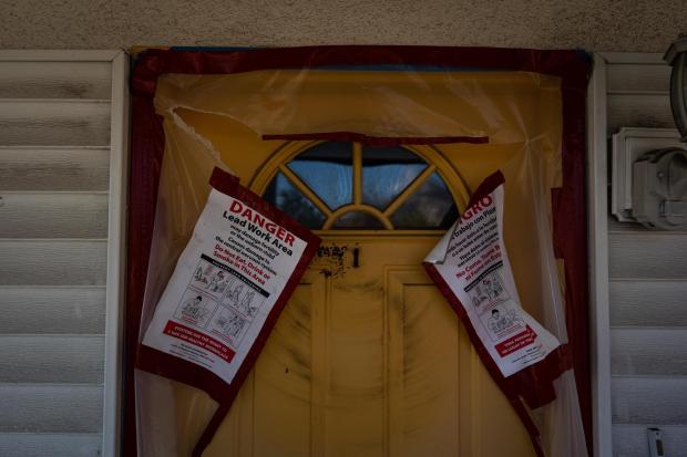 Warning notices are posted on the door of a home that survived the Eaton Fire, Dec. 3, 2025, in Altadena, Calif. (AP Photo/Jae C. Hong)
