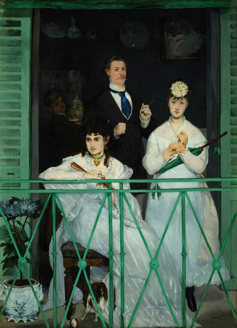 Three people in formal attire stand and sit on a balcony with green shutters; a small dog is at their feet and blue flowers are in the foreground.