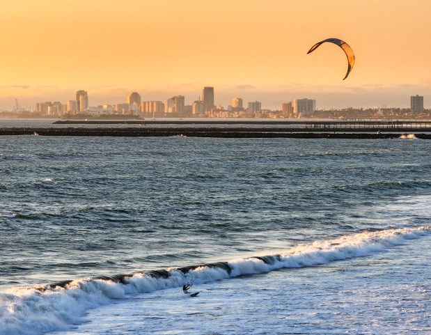 A kite surfer rides the wind off the coast of Sunset Beach in Huntington Beach in November. (Photo by Jeff Gritchen, Orange County Register/SCNG)