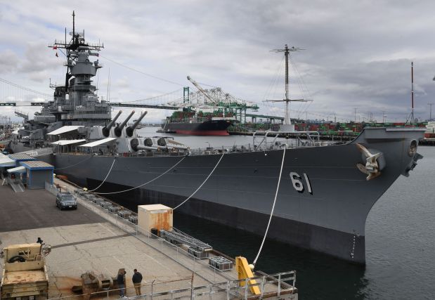 A container ship unloads its cargo beside the Battleship USS Iowa at the main port terminal in Long Beach, May 10, 2019.(Photo by Mark RALSTON / AFP)