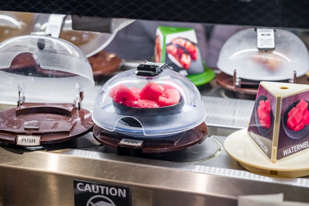 Food items pass by customers on a conveyor belt inside Kura Revolving Sushi Bar at the Brea Mall in Brea on Wednesday, November 19, 2025. (Photo by Leonard Ortiz, Orange County Register/SCNG)
