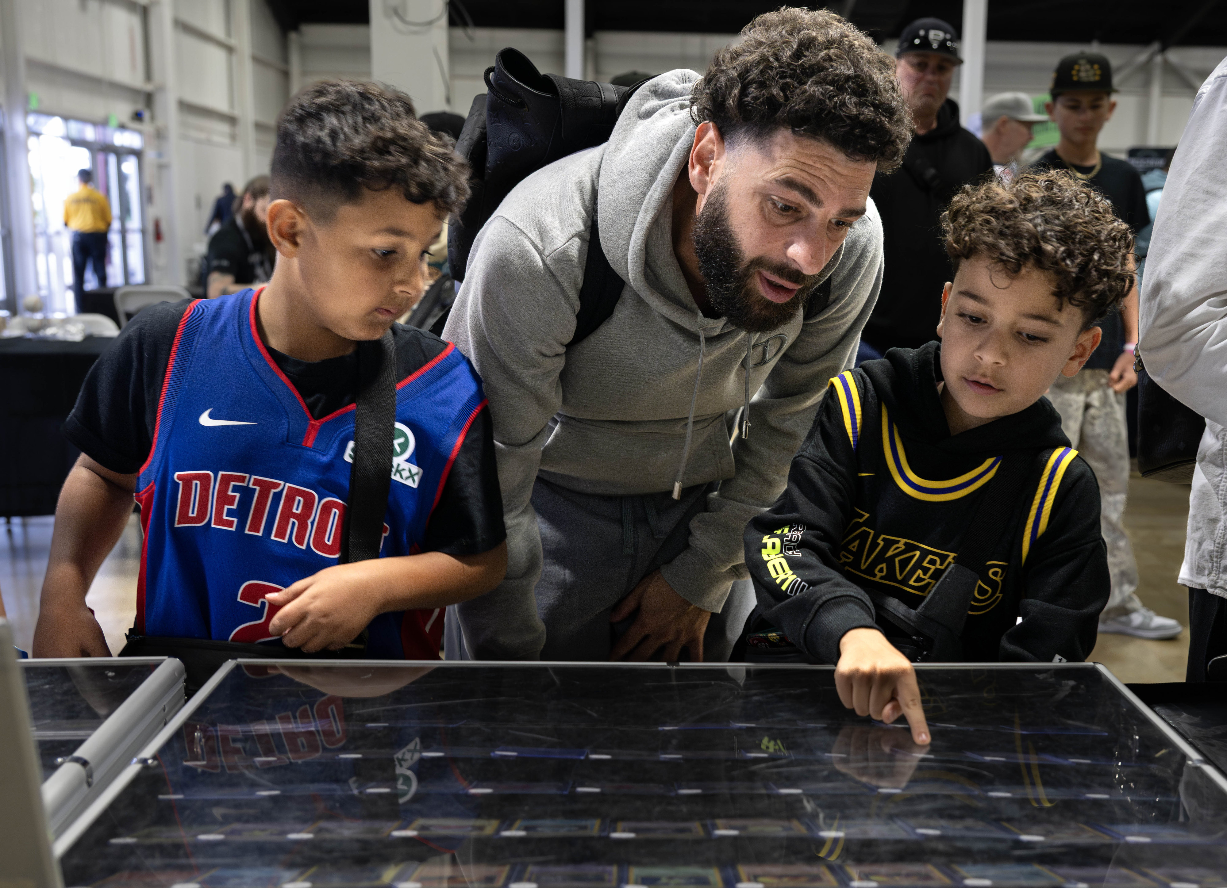 Adam Abdelraman checks out Pokemon cards with his 8-year-old son...