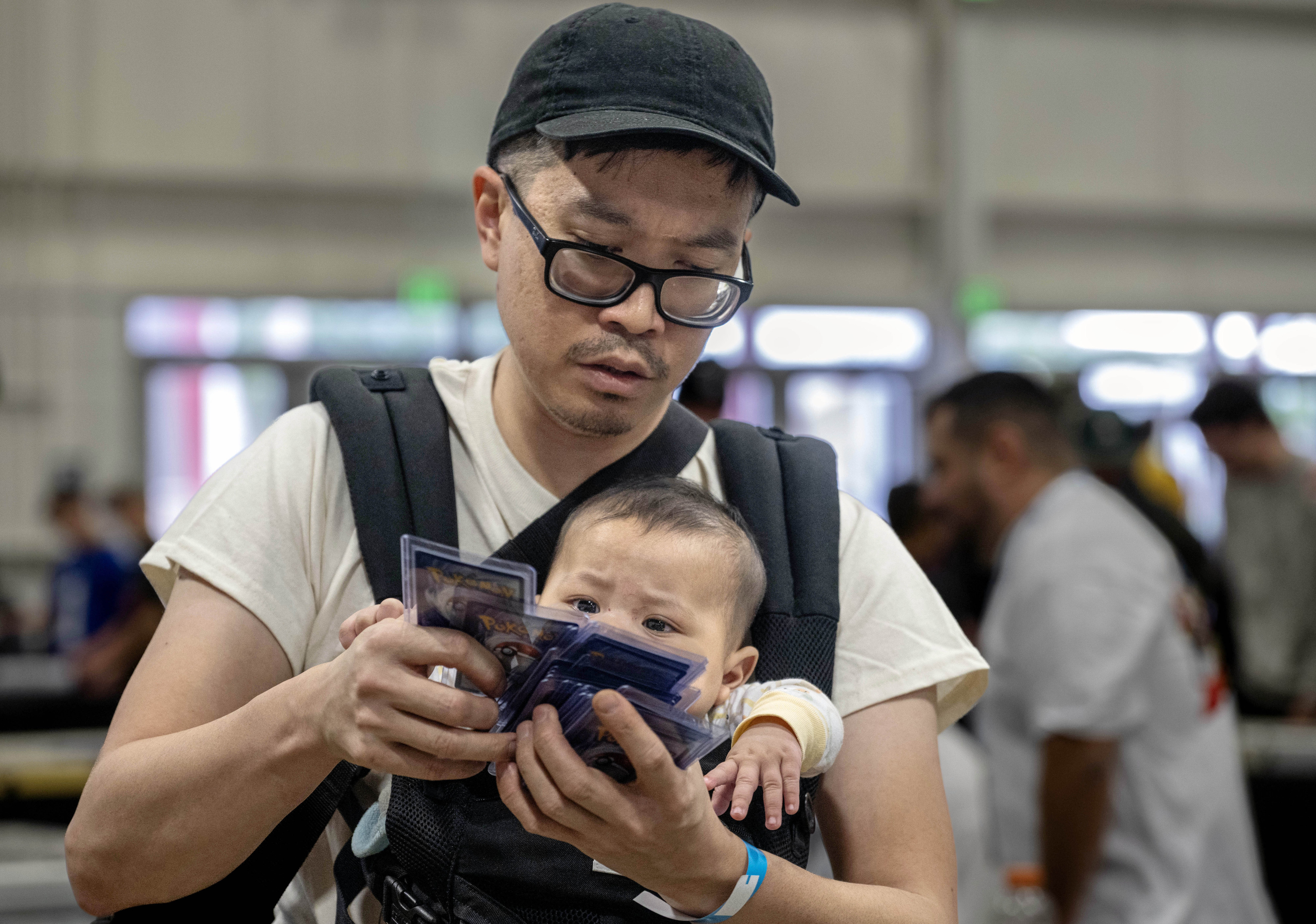 Lamdon Yu organizes Pokemon cards he plans on selling at...