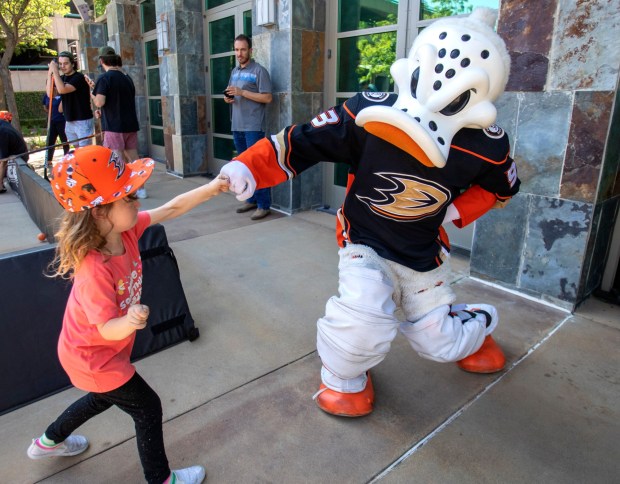 Six-year-old Hayden Kennar, left, connects with Anaheim Ducks Wild Wing on hand to help design a new playground and park with local kids during a public session in Anaheim, on Friday, July 15, 2022. (Photo by Alex Gallardo, Contributing Photographer)