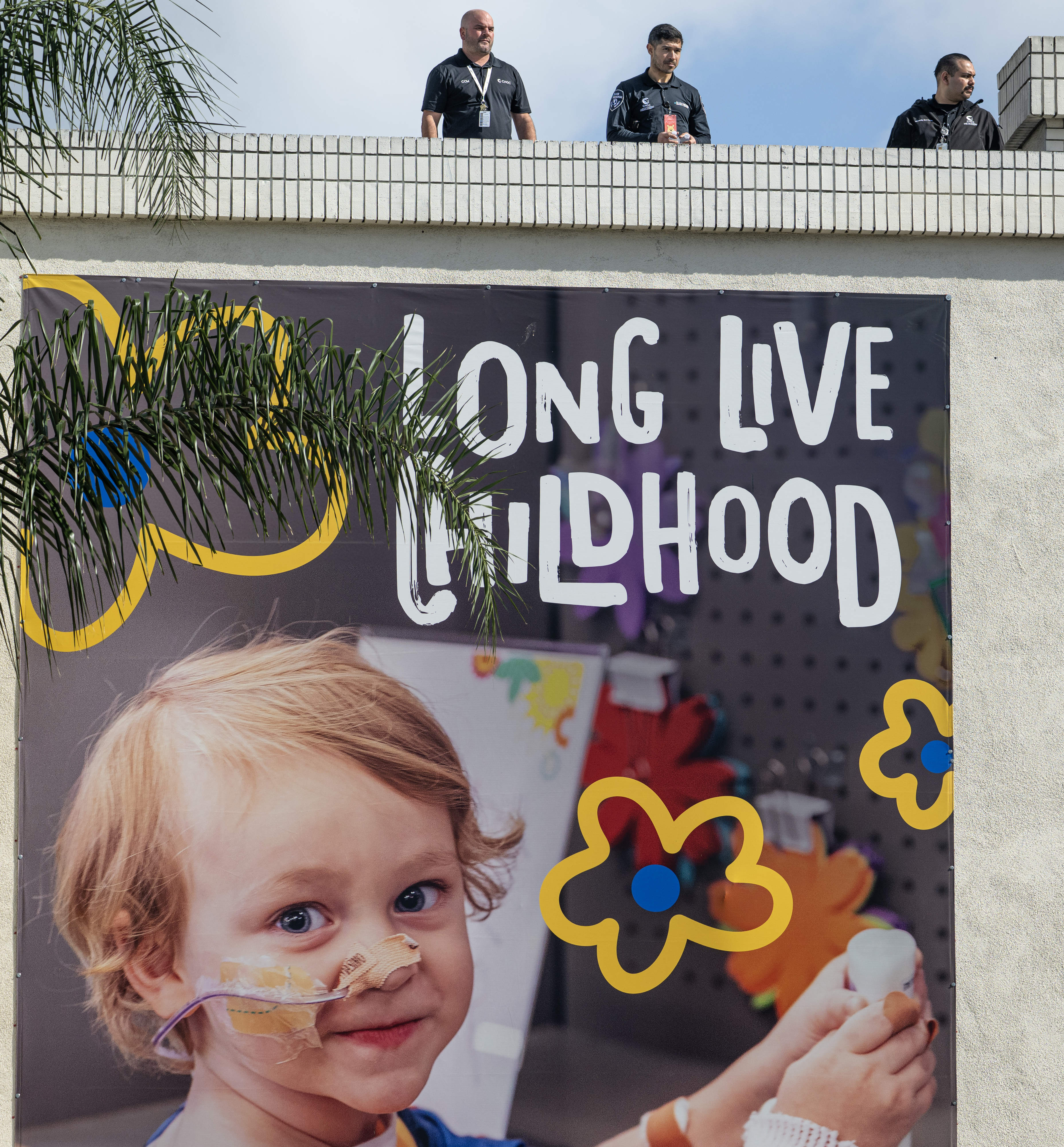 Security guards atop the Childrenâs Hospital of Orange County building...