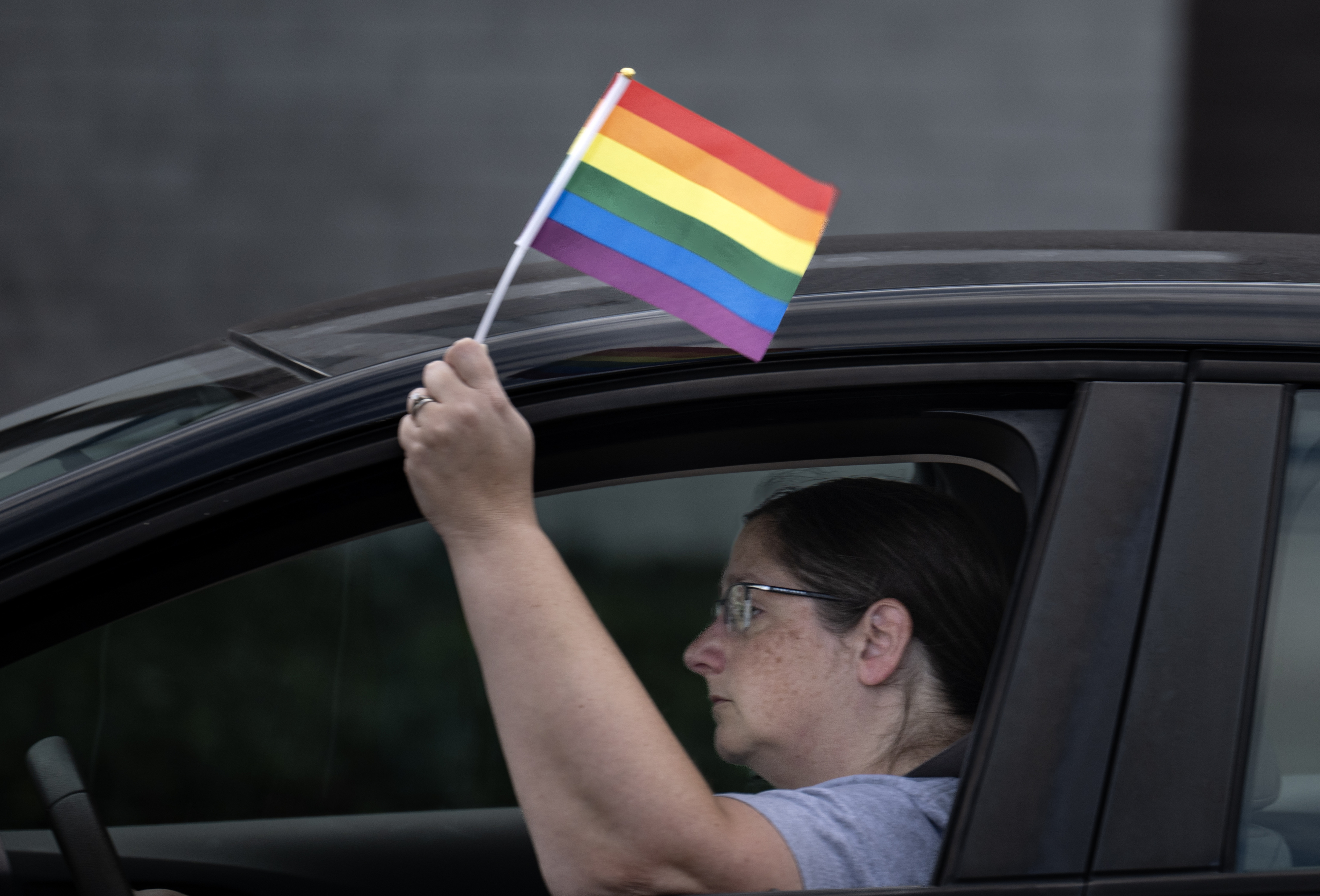 A motorist passing “Patients Before Politics” demonstrators shows her support...