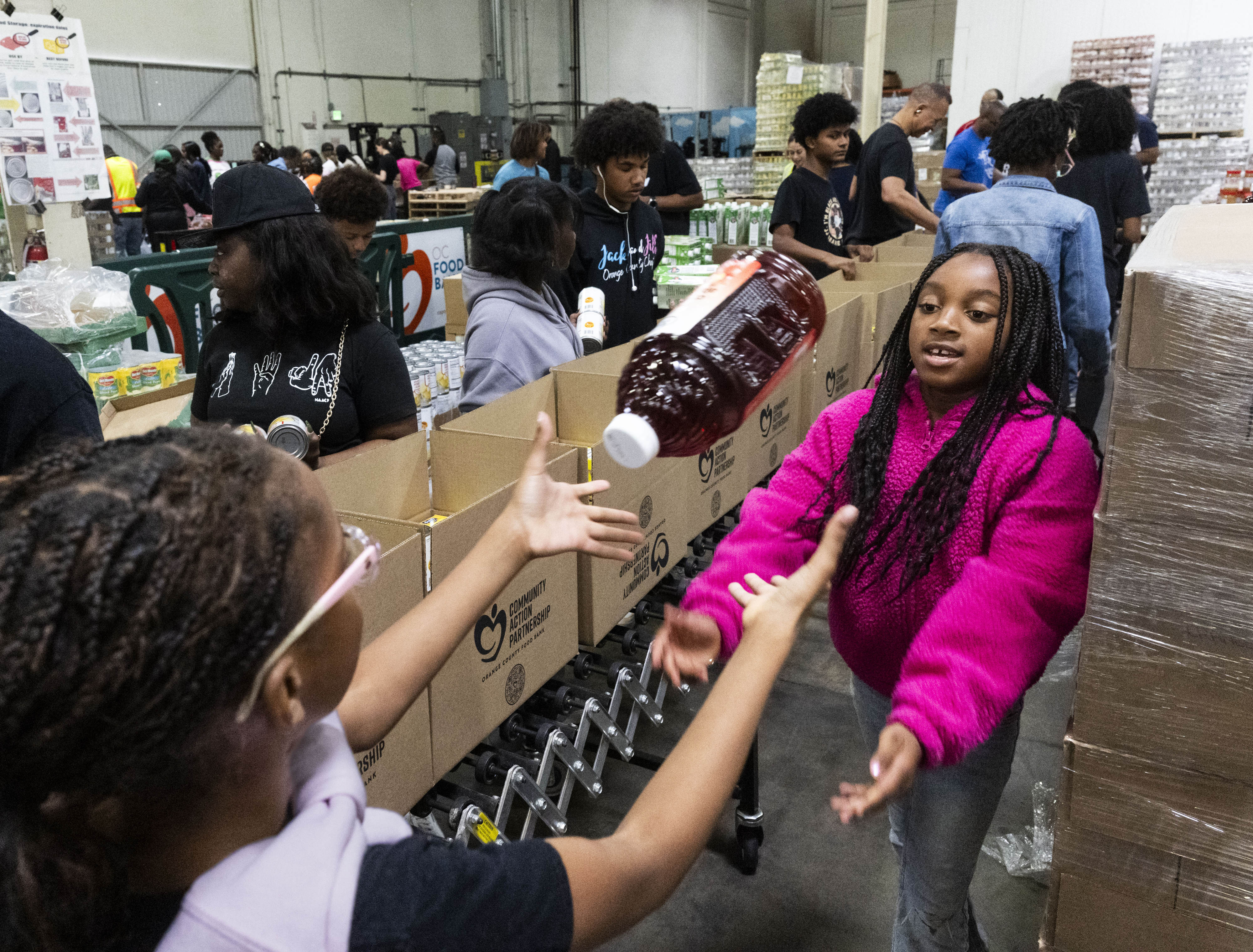 Leah Rose Robinson, right, passes a juice to Rali Westmorland...
