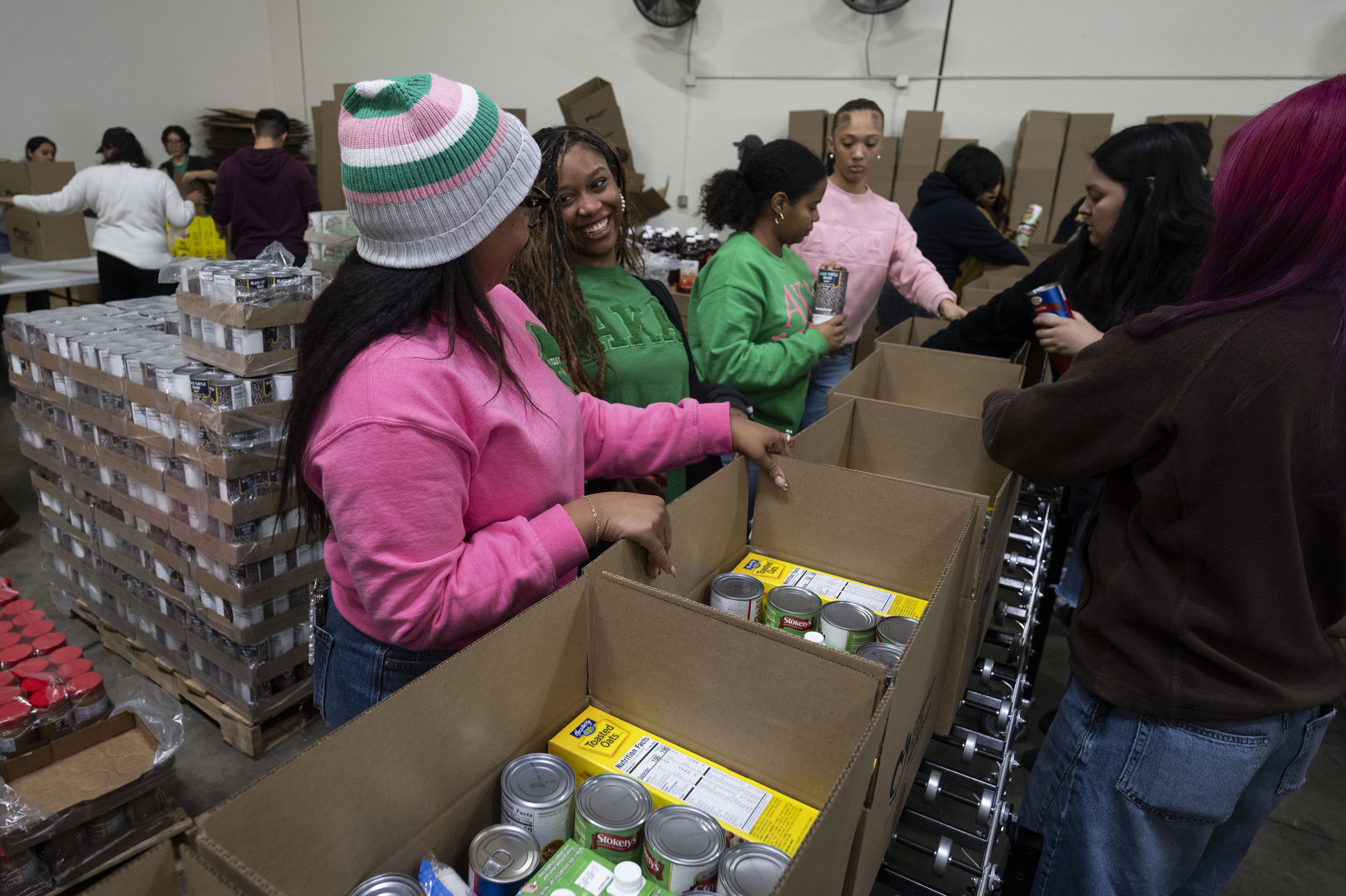 Lonneshia Burrell and Makenna Roberson, from left, laugh while packing...