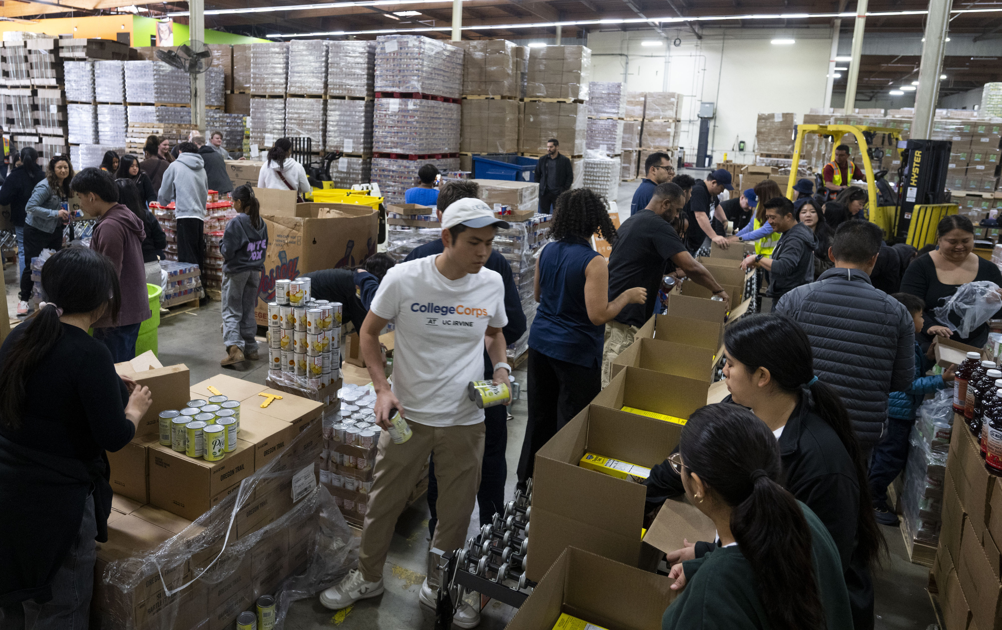 Volunteers pack boxes of shelf-stable food during the Martin Luther...