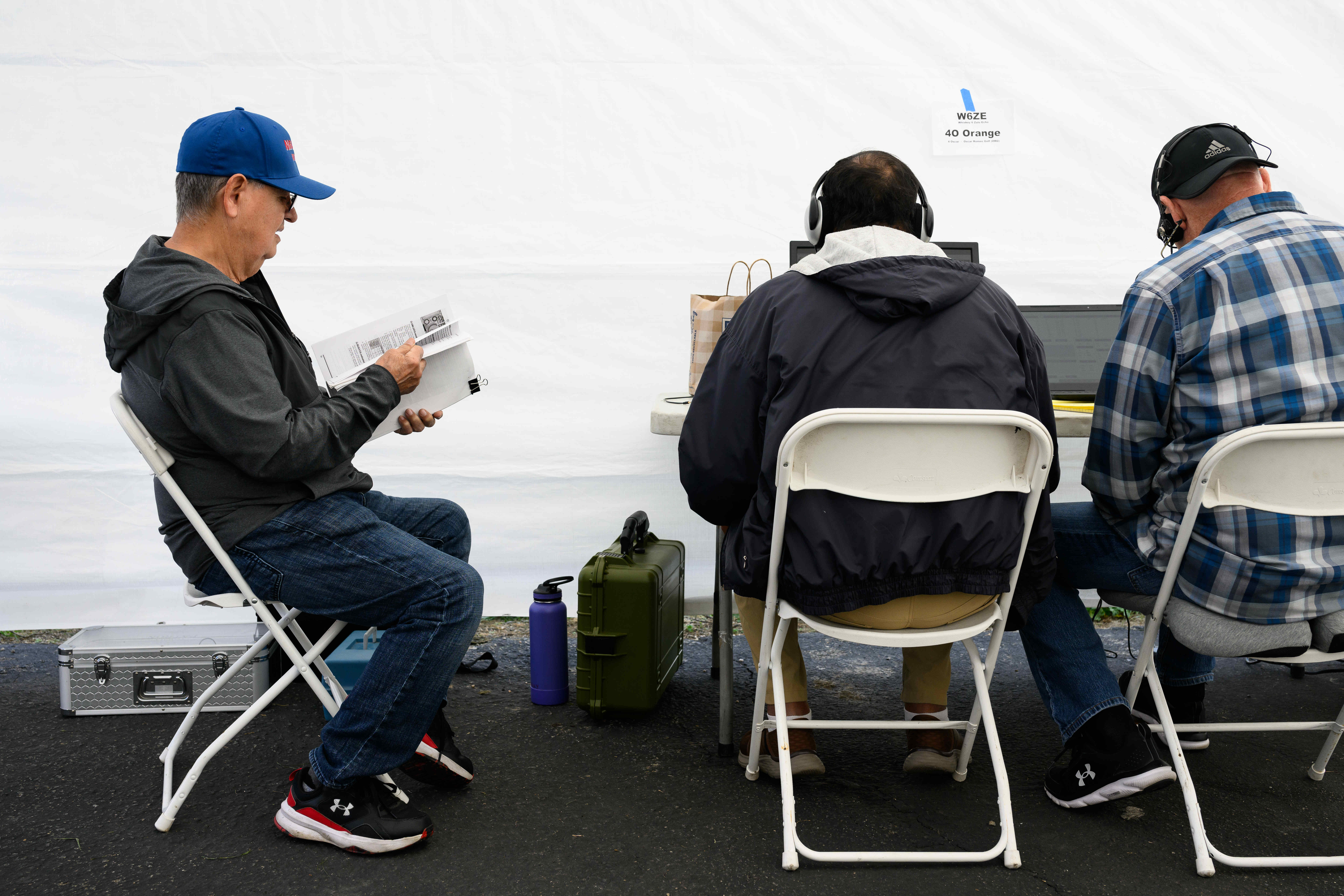 Willy Bustamante, left, looks through an operation manual for the...