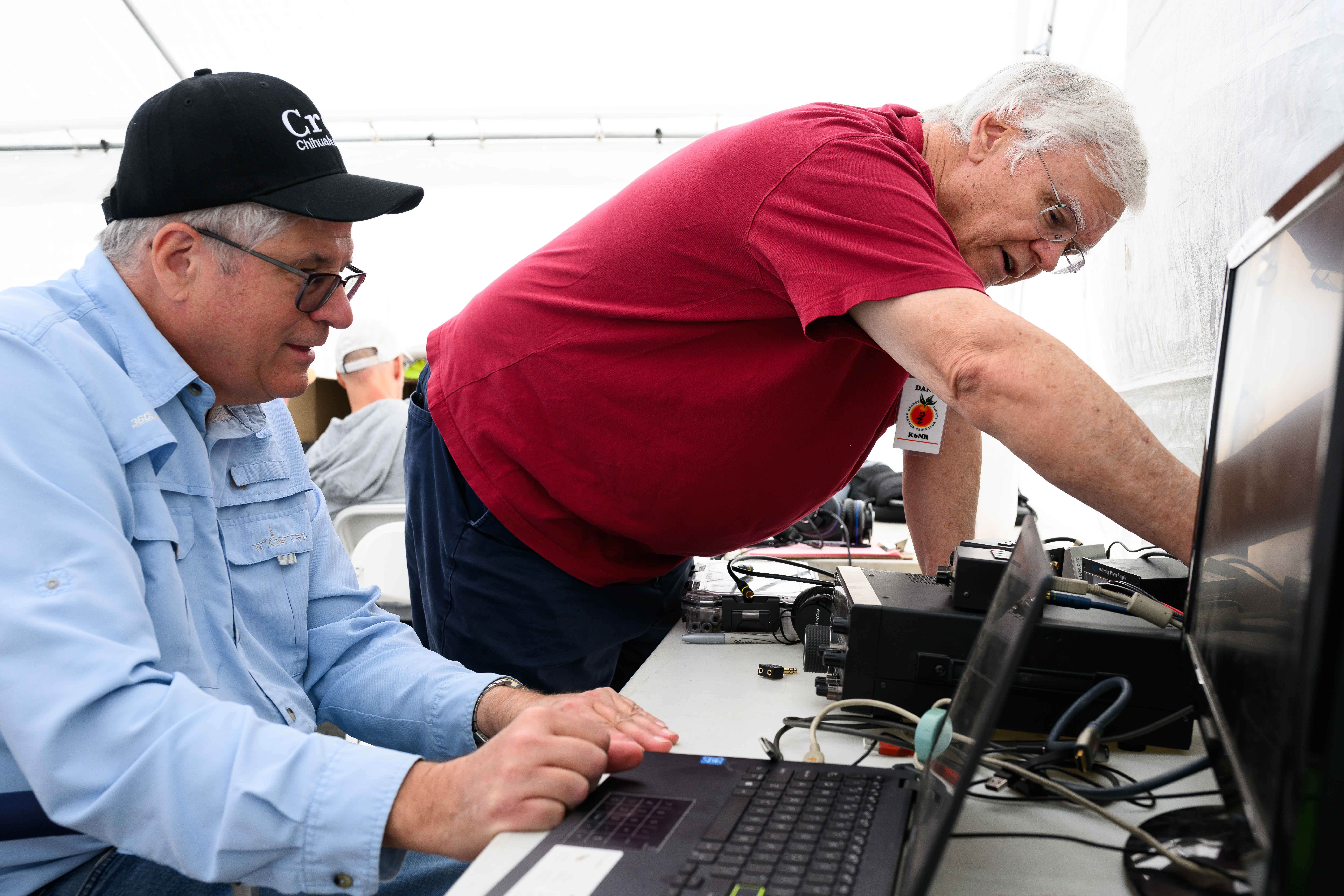 Tim Goeppinger, left, and Dana Roode troubleshoot an issue in...