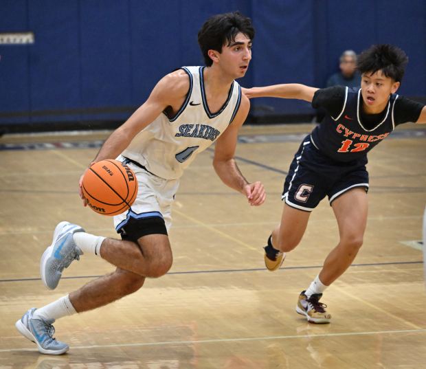 Corona del Mar's Luke Mirhashemi (0) looks for an opening as Cypress' Terrence Hoang (12) guards in the second quarter of a North/South Challenge boys basketball game, December 23, 2025, at Tesoro High School in Rancho Santa Margarita.(Photo by Steven Georges, Contributing Photographer)
