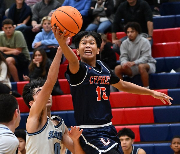 Corona del Mar's Luke Mirhashemi (0) tries to block as Cypress' Brennen DeLa Cruz (15) leaps to score in the third quartter of a North/South Challenge boys basketball game, December 23, 2025, at Tesoro High School in Rancho Santa Margarita.(Photo by Steven Georges, Contributing Photographer)