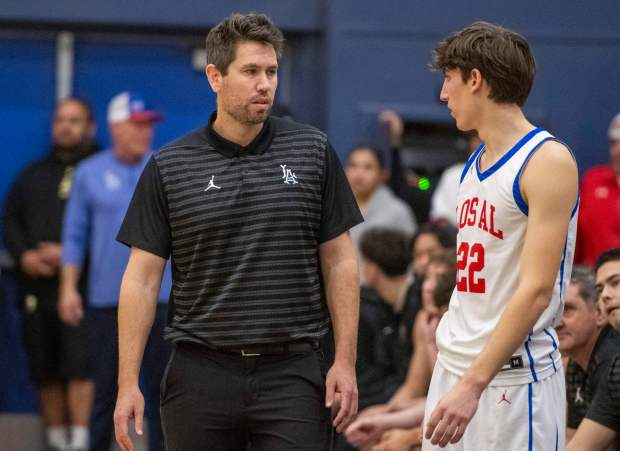 Los Alamitos head coach Nate Berger talks to Tyler Lopez (22) during a boys basketball playoff game between Long Beach Poly High and Los Alamitos High in the second round of the CIF-SS Division 1 playoffs at Los Alamitos High School on Friday Feb. 14, 2025.(Photo by Michael Goulding, Contributing Photographer)