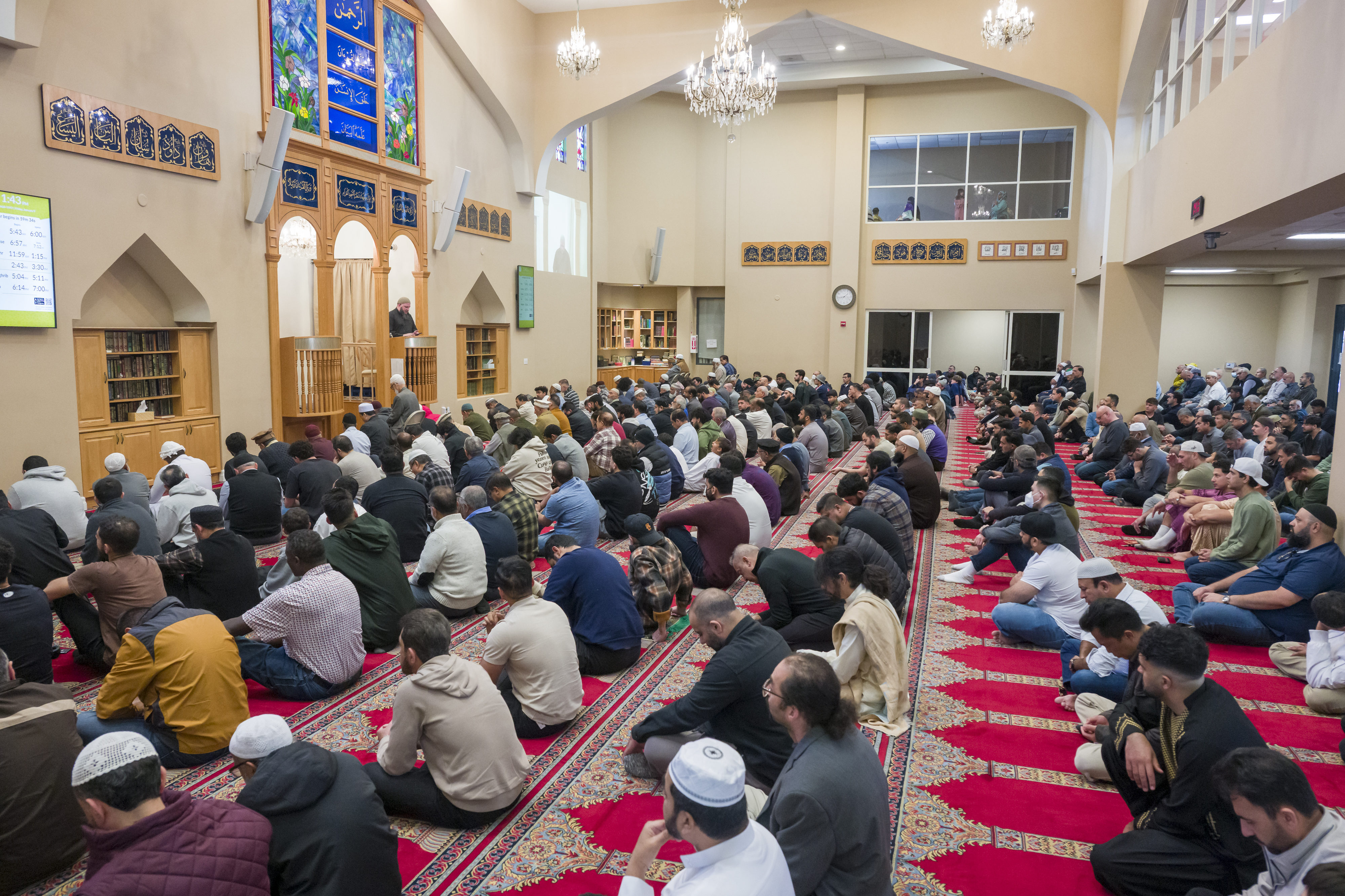 Imam Fayaz Nawabi, left, gives a sermon at the Islamic...