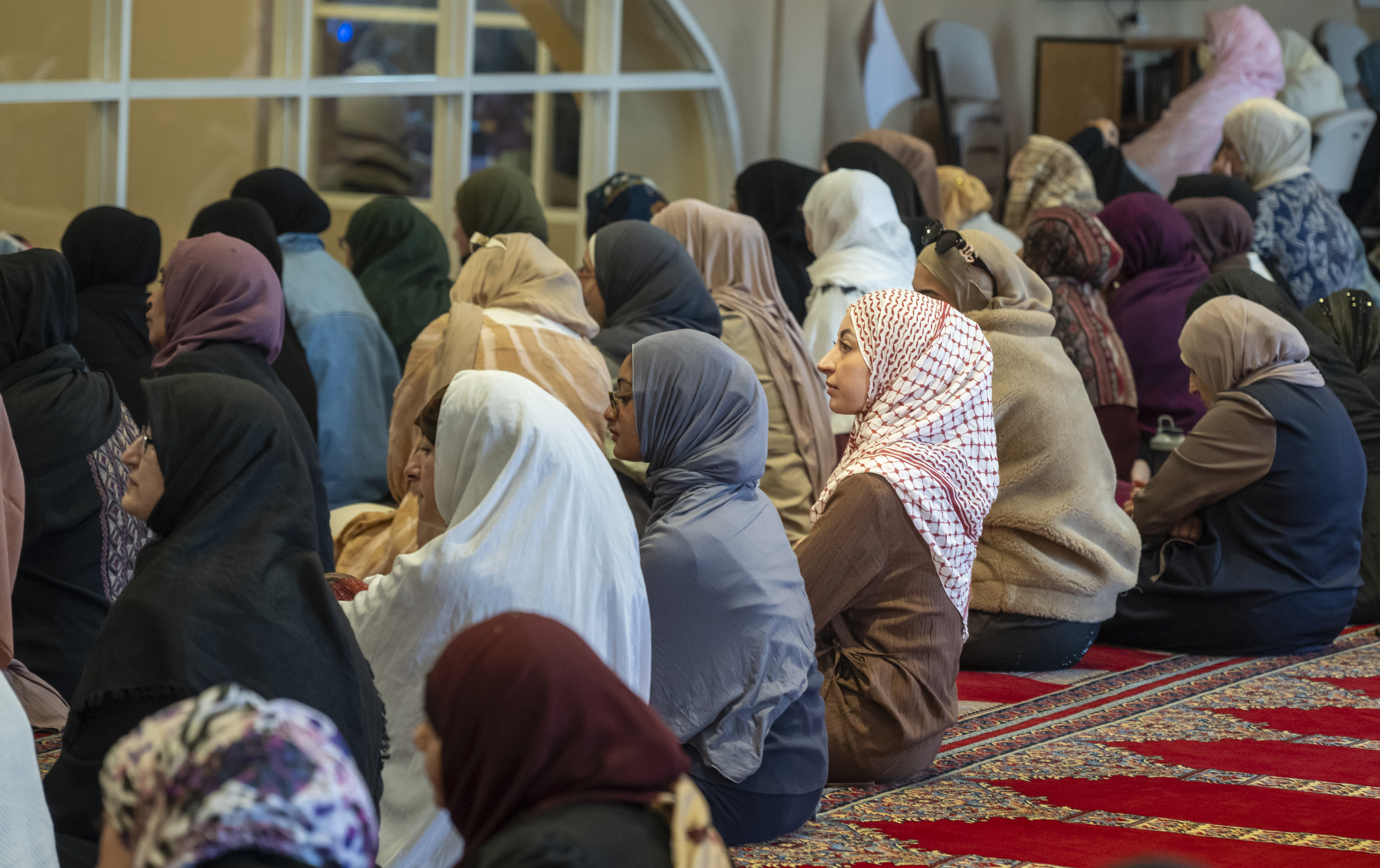 Women gather for the prayer service at the Islamic Society...