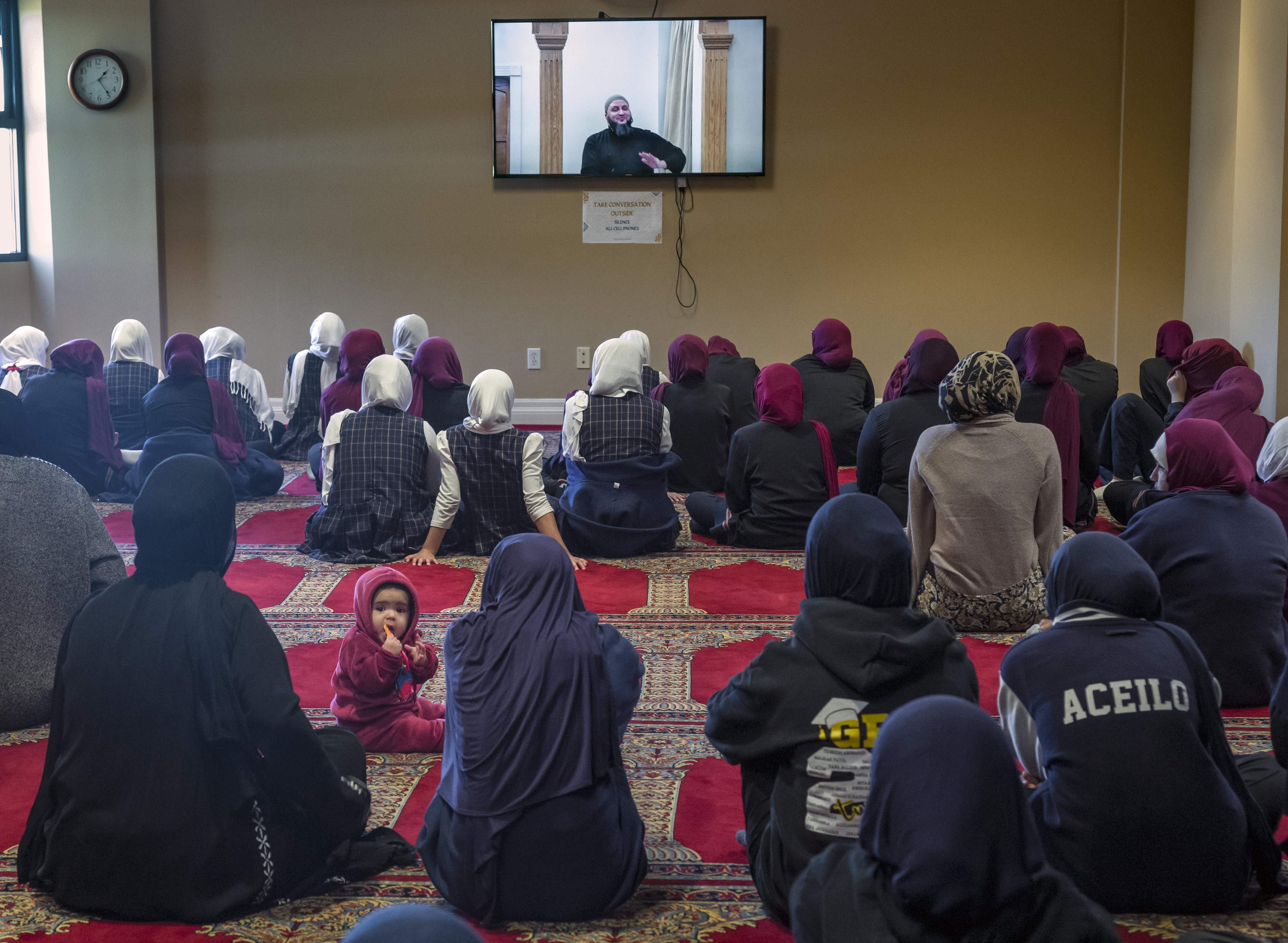 Female teens and children gather in the womenâs prayer room...
